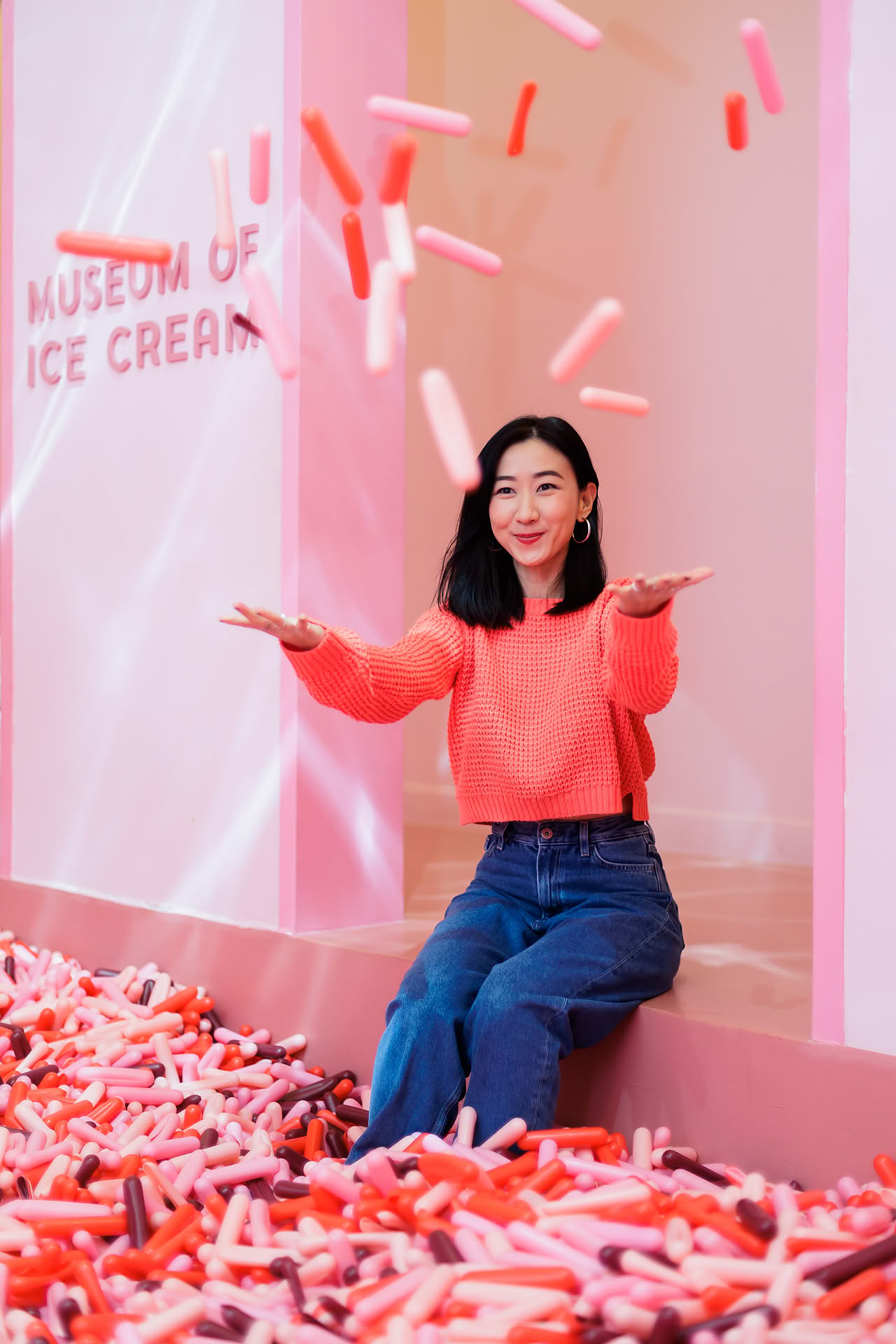 Influencer playing in ball pit