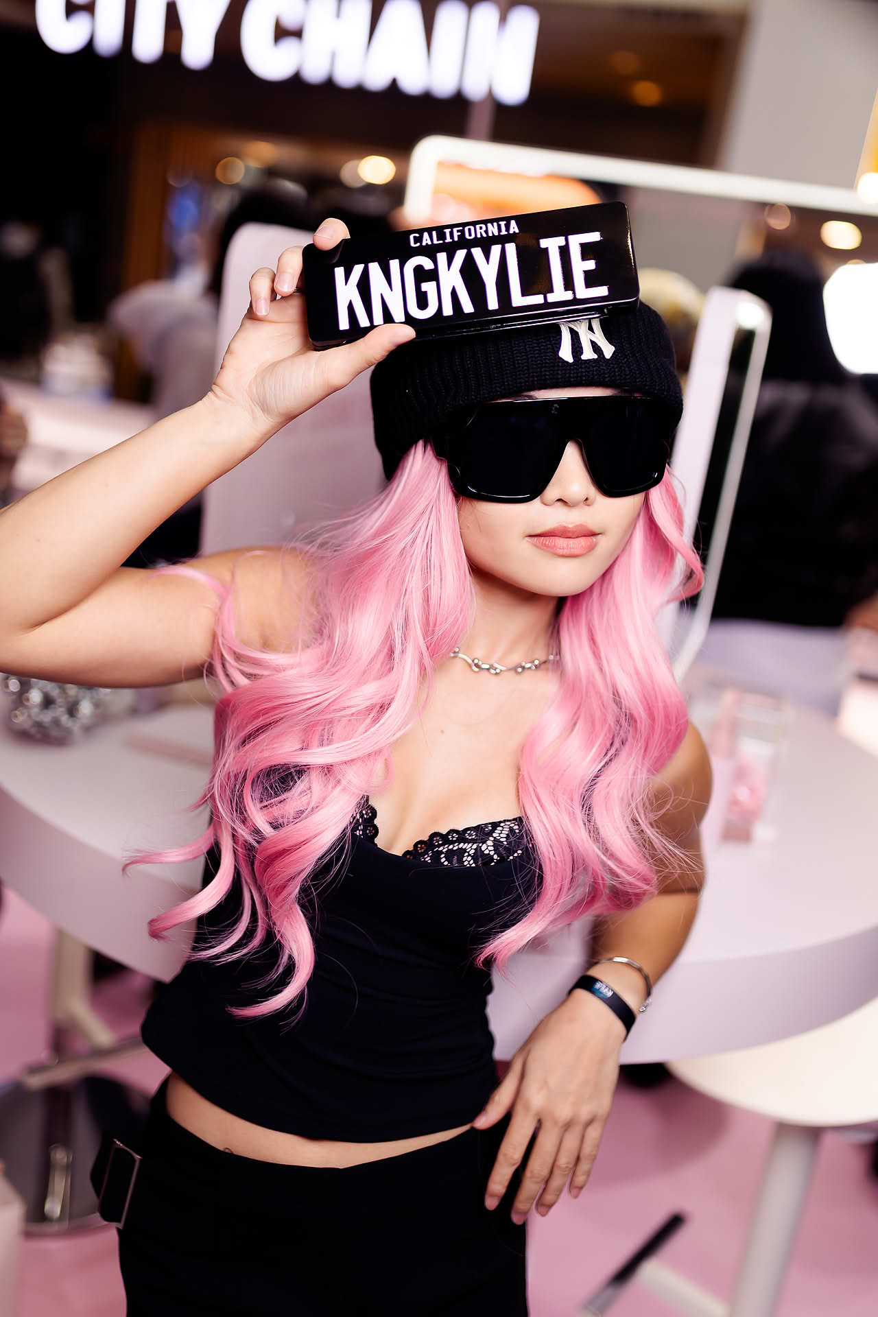 Influecer posing at Kylie Cosmetics pop-up stall in Bugis Junction