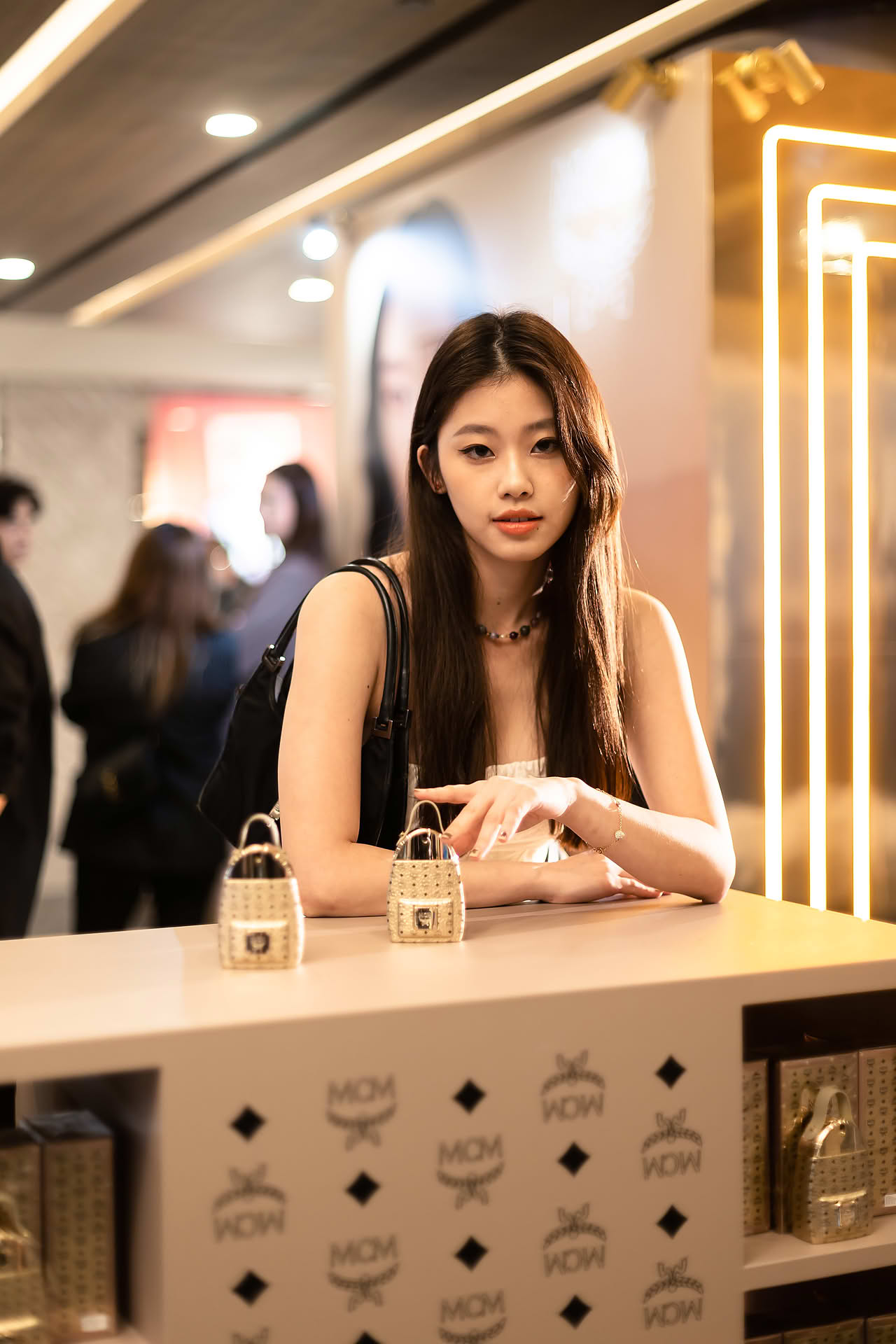 Influencer posing with MCM Ultra perfume to promote pop-up store