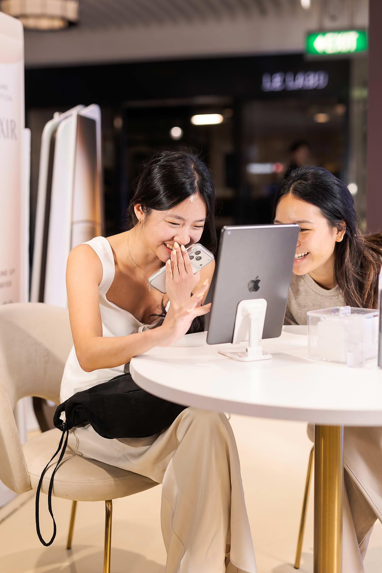 Model taking beauty assement at Exlixir pop-up stall in Ngee Ann City