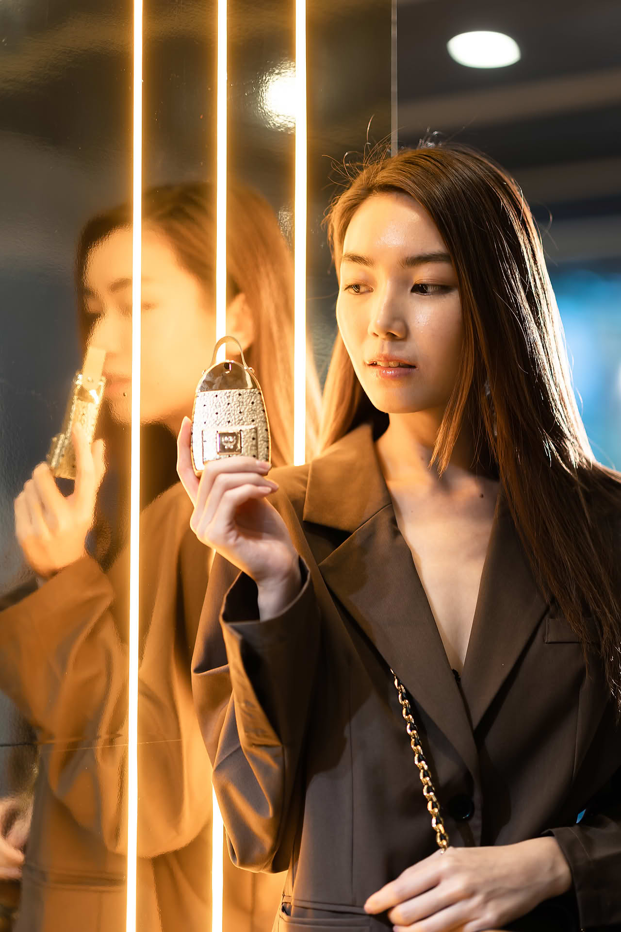 Influencer posing with MCM Ultra perfume to promote pop-up store