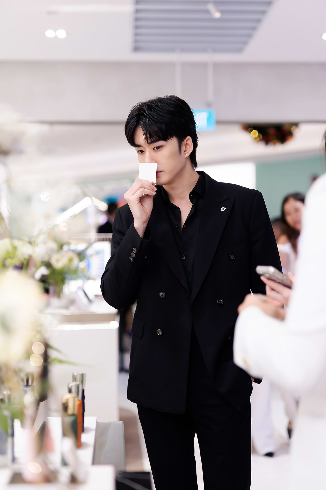 Singer smelling perfume at Parfums de Marly launch event