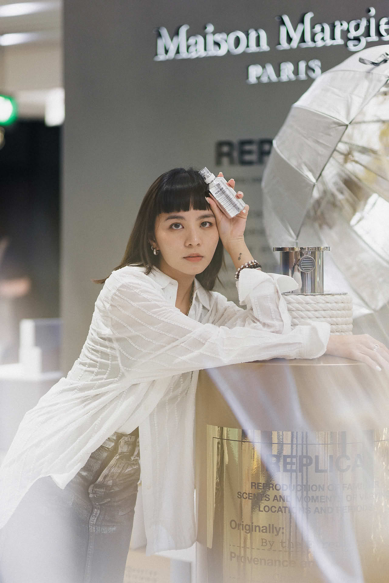 Influencer posing at Maison Margiela pop-up stall in Ngee Ann City
