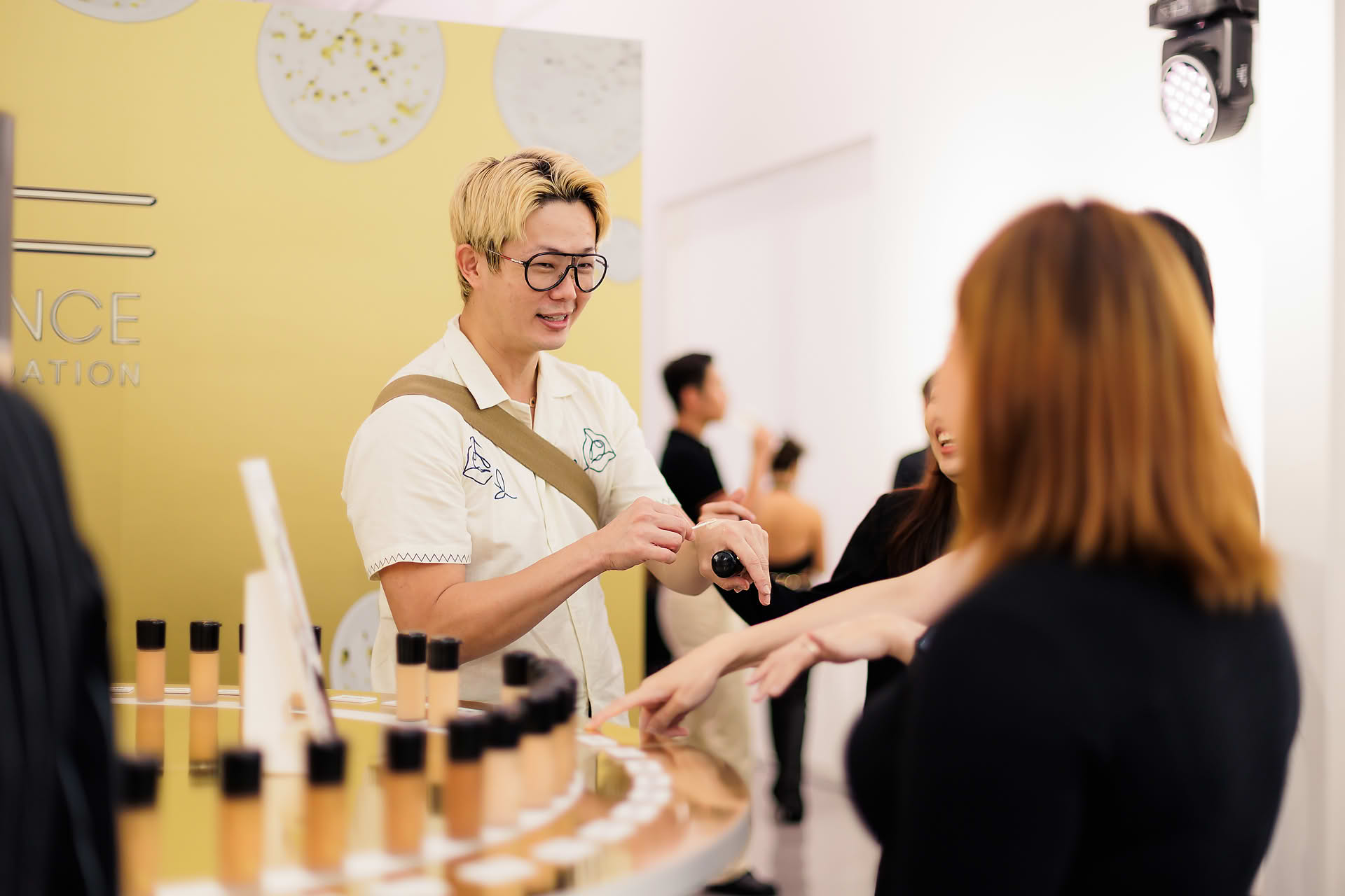Makeup artist demonstrating at MAC Cosmestics PR event