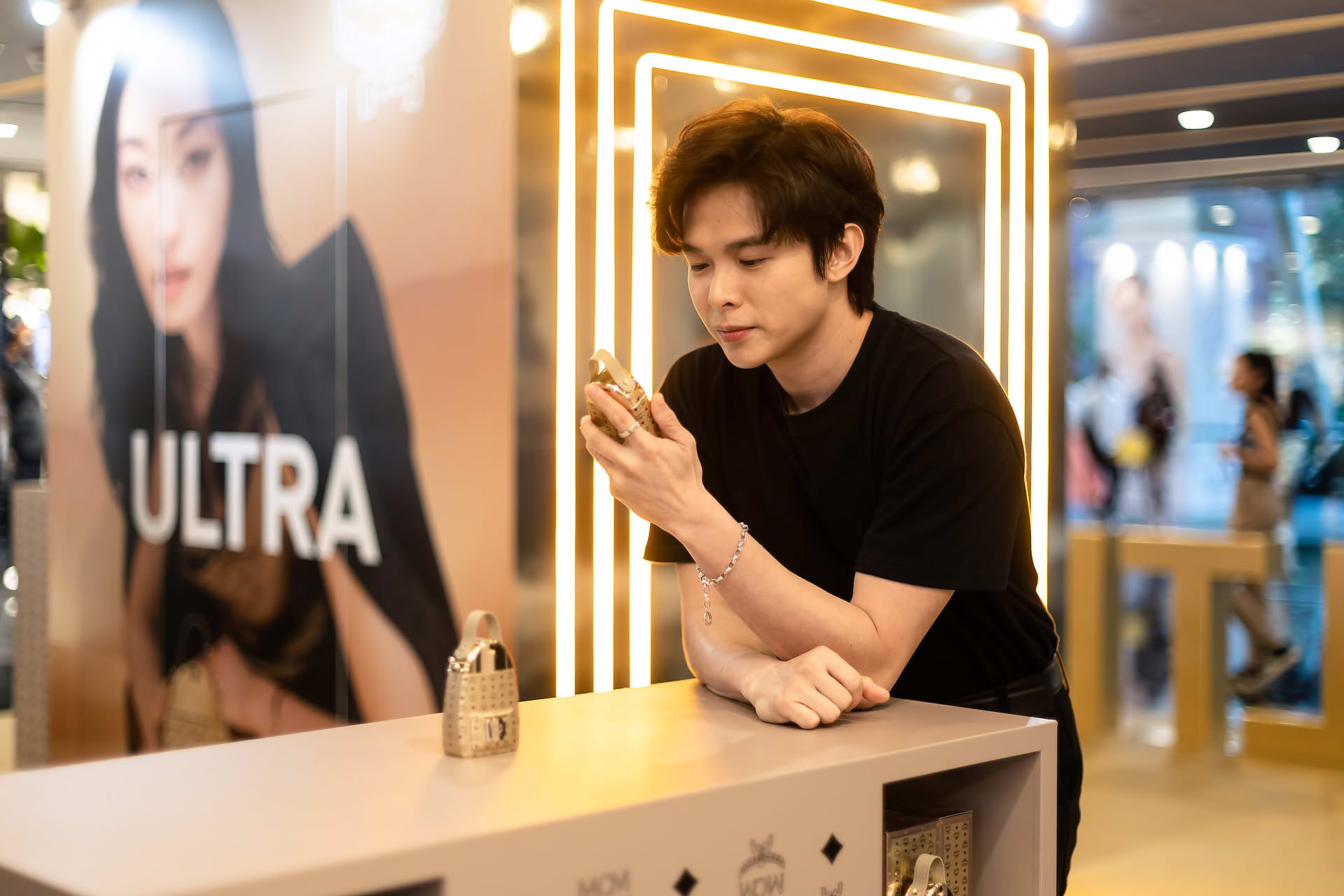 Influencer posing with MCM Ultra perfume to promote pop-up store