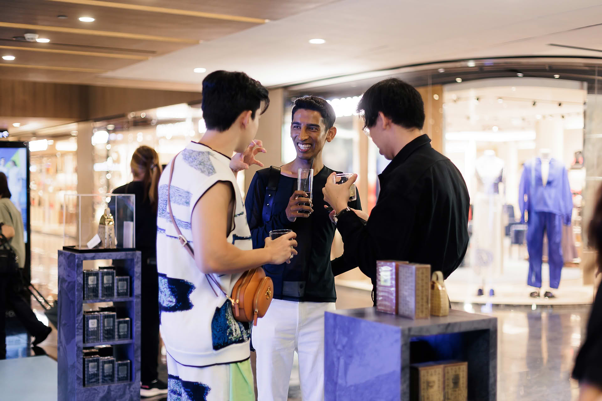 Influencers chating over drinks at MCM pop-up stall at Paragon