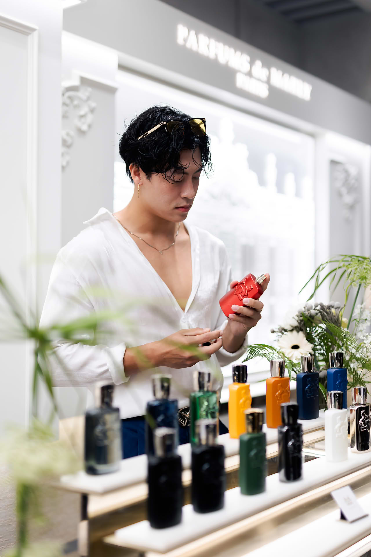 Influencer looking at perfume at Parfums de Marly launch event