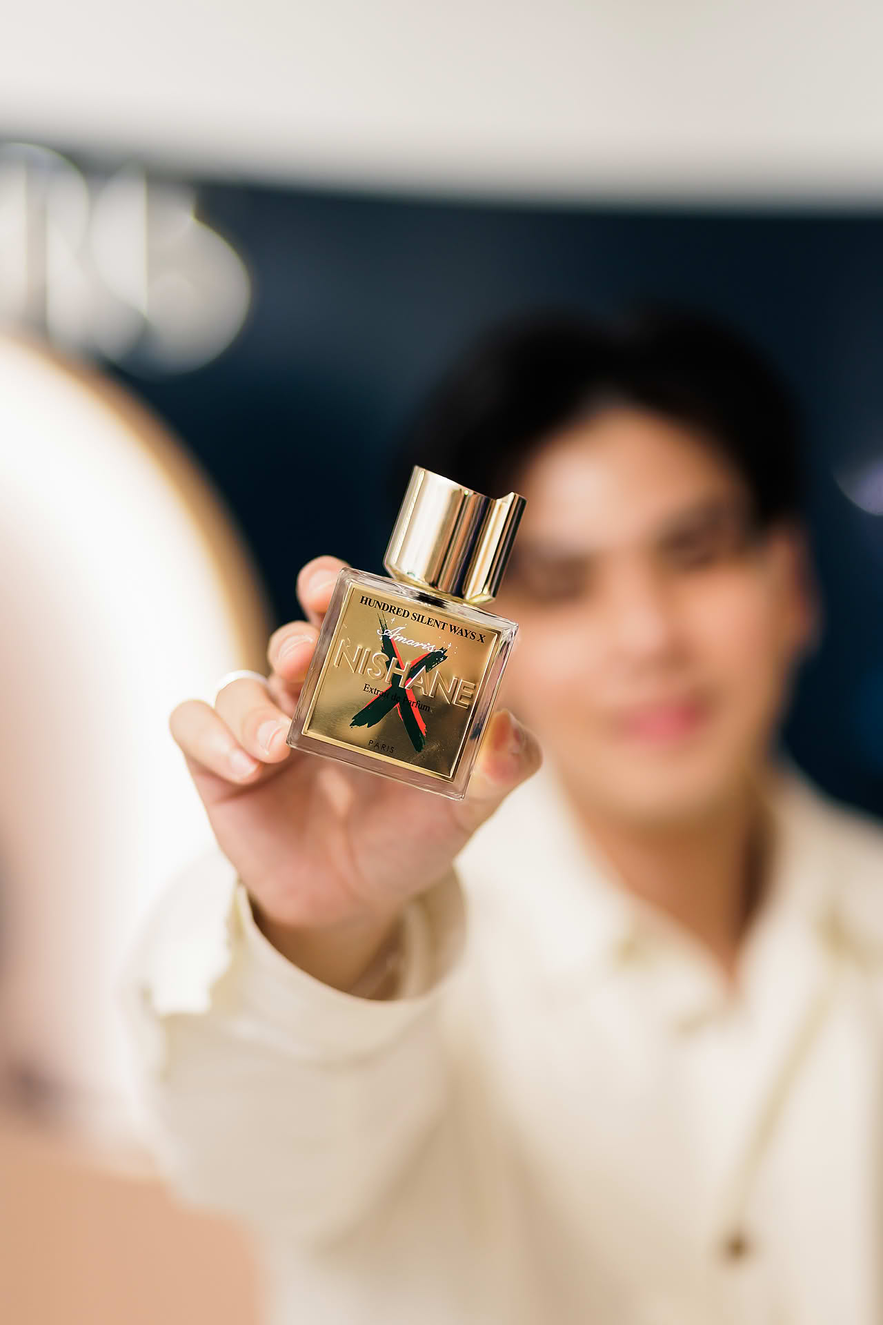Influncer holding up Nishane Extra de Parfum