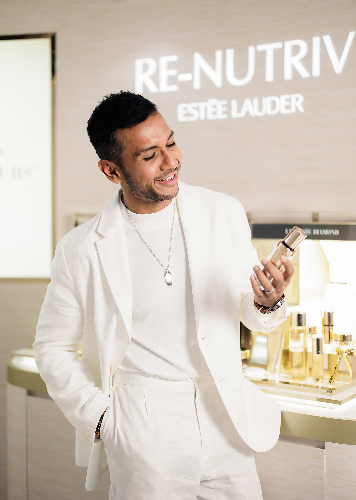 Taufik Batisah posing with product at Estee Lauder Yoona PR event in Paragon