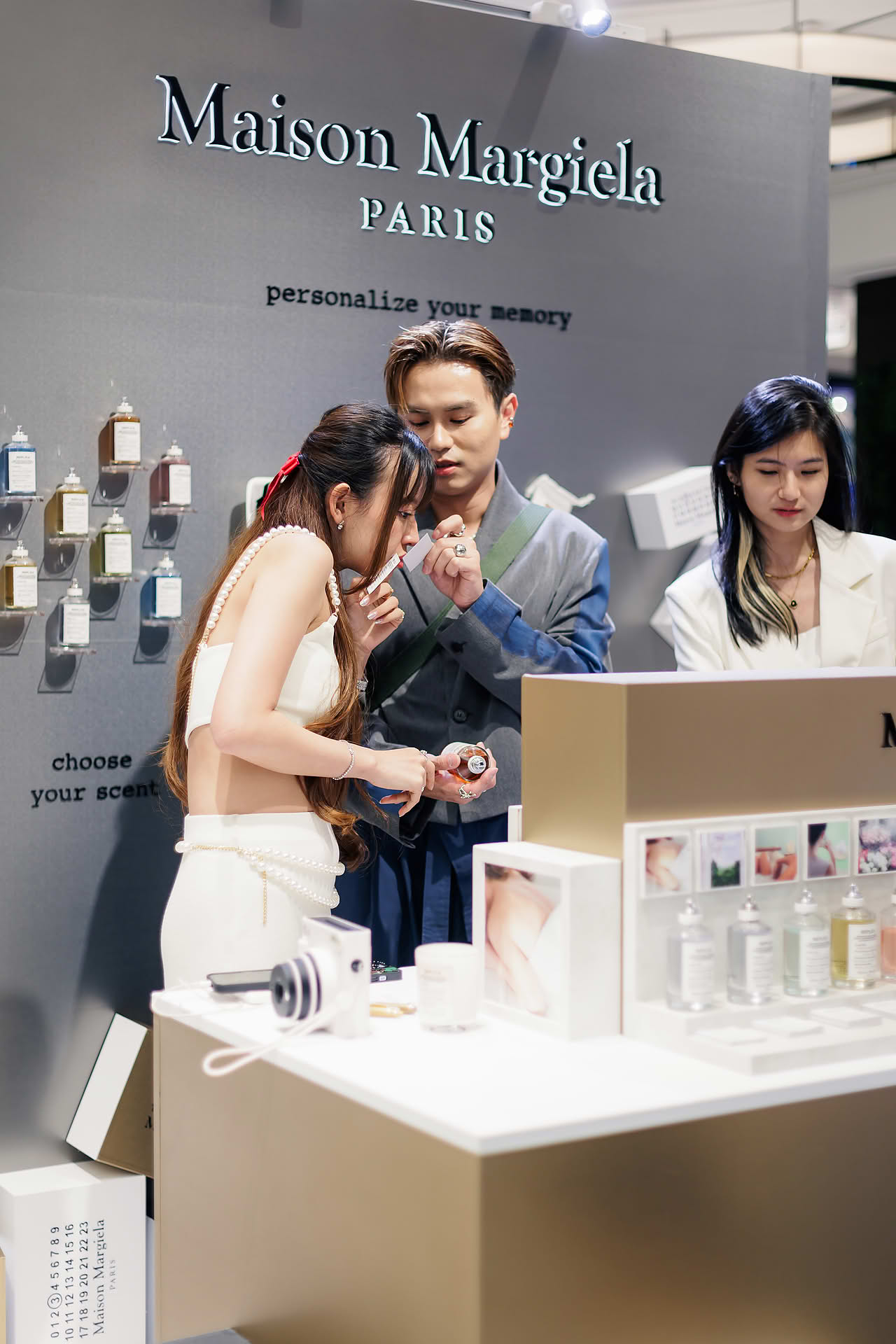 Influencers smelling perfume at Maison Margiela pop-up stall in Ngee Ann City