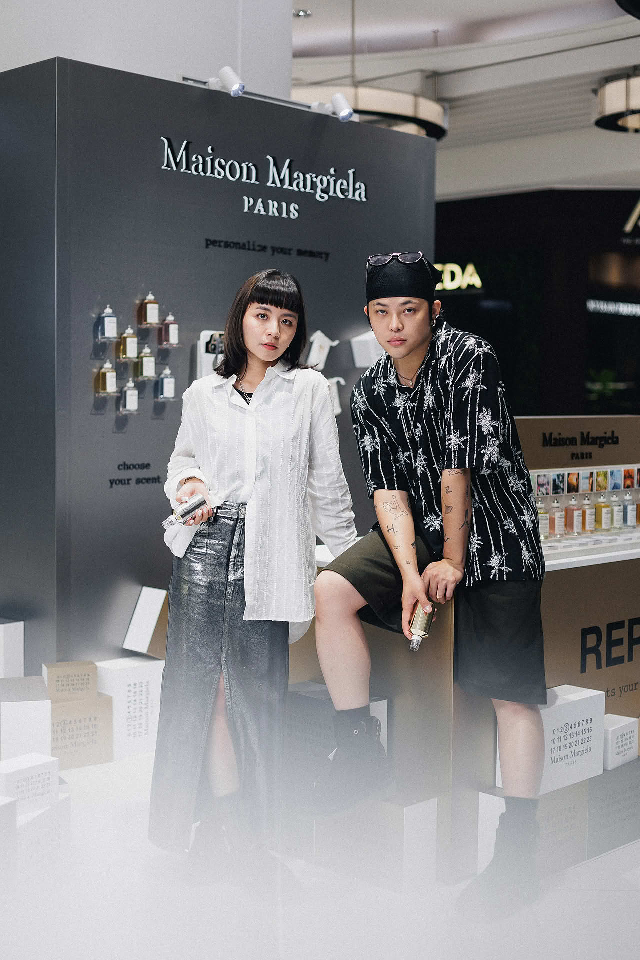 Influencers posing at Maison Margiela pop-up stall in Ngee Ann City