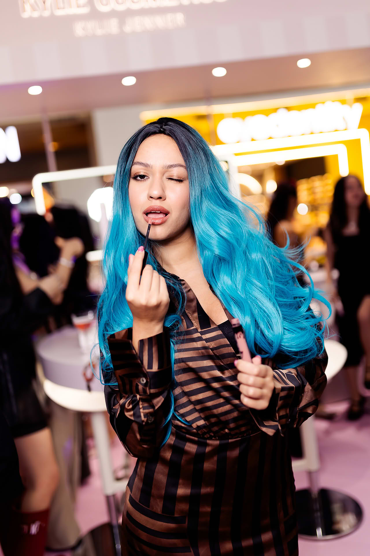 Influecer posing at Kylie Cosmetics pop-up stall in Bugis Junction