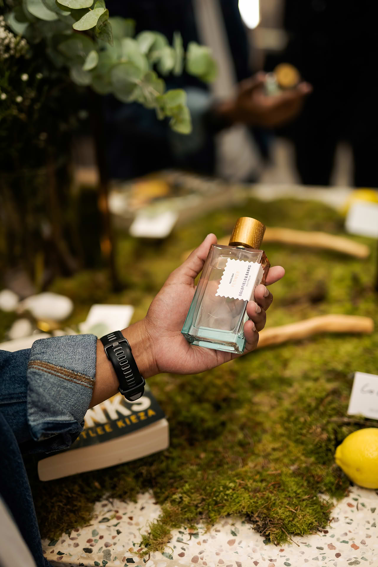 Hand holding a perfume at Goldfield & Banks PR event