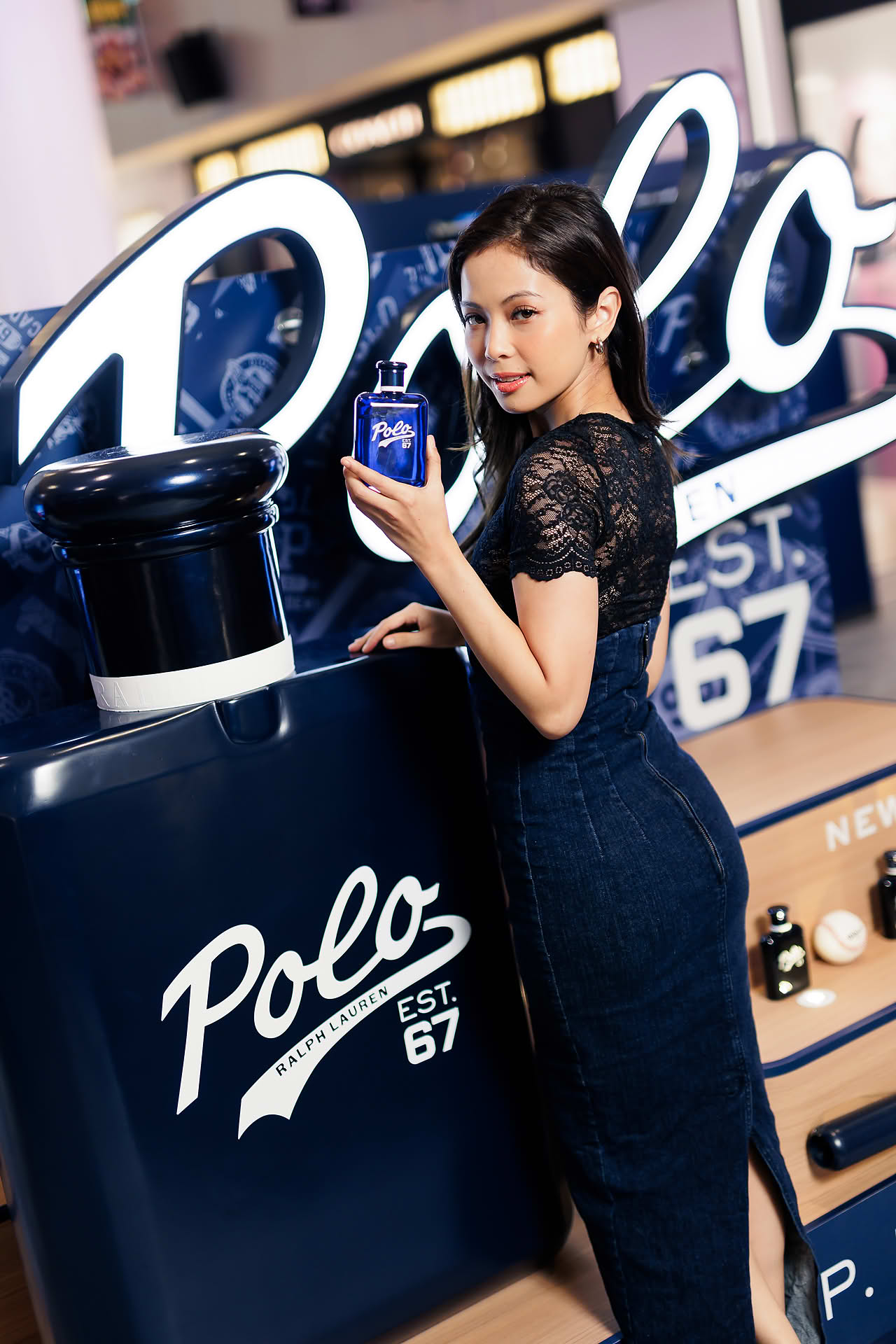 Influencer posing with Ralph Lauren Perfume at pop-up stall in Vivocity