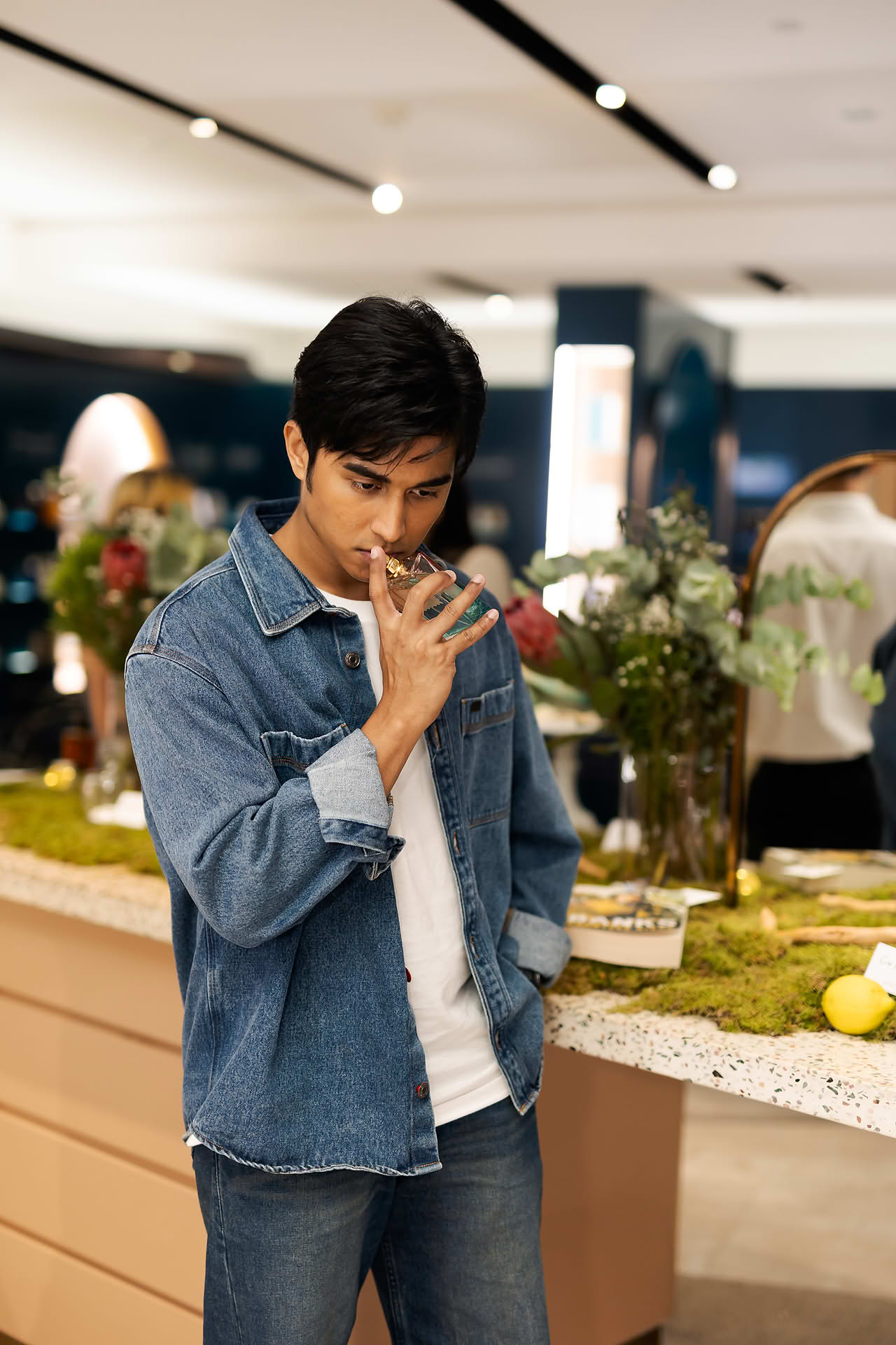 Actor smelling perfume at Goldfield & Banks PR event