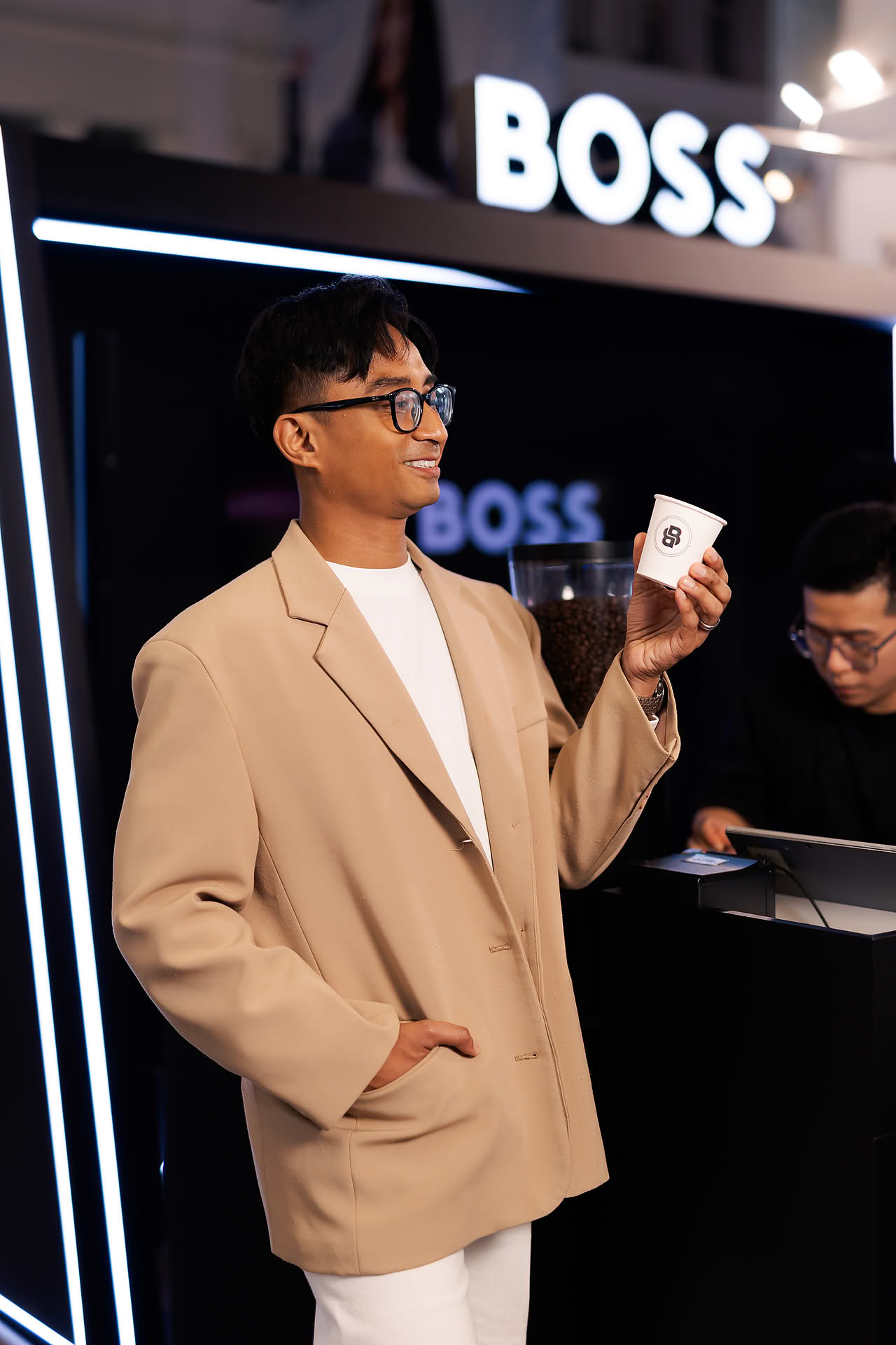 Guest drinking coffee served at BOSS pop-up stall in Bugis Junction