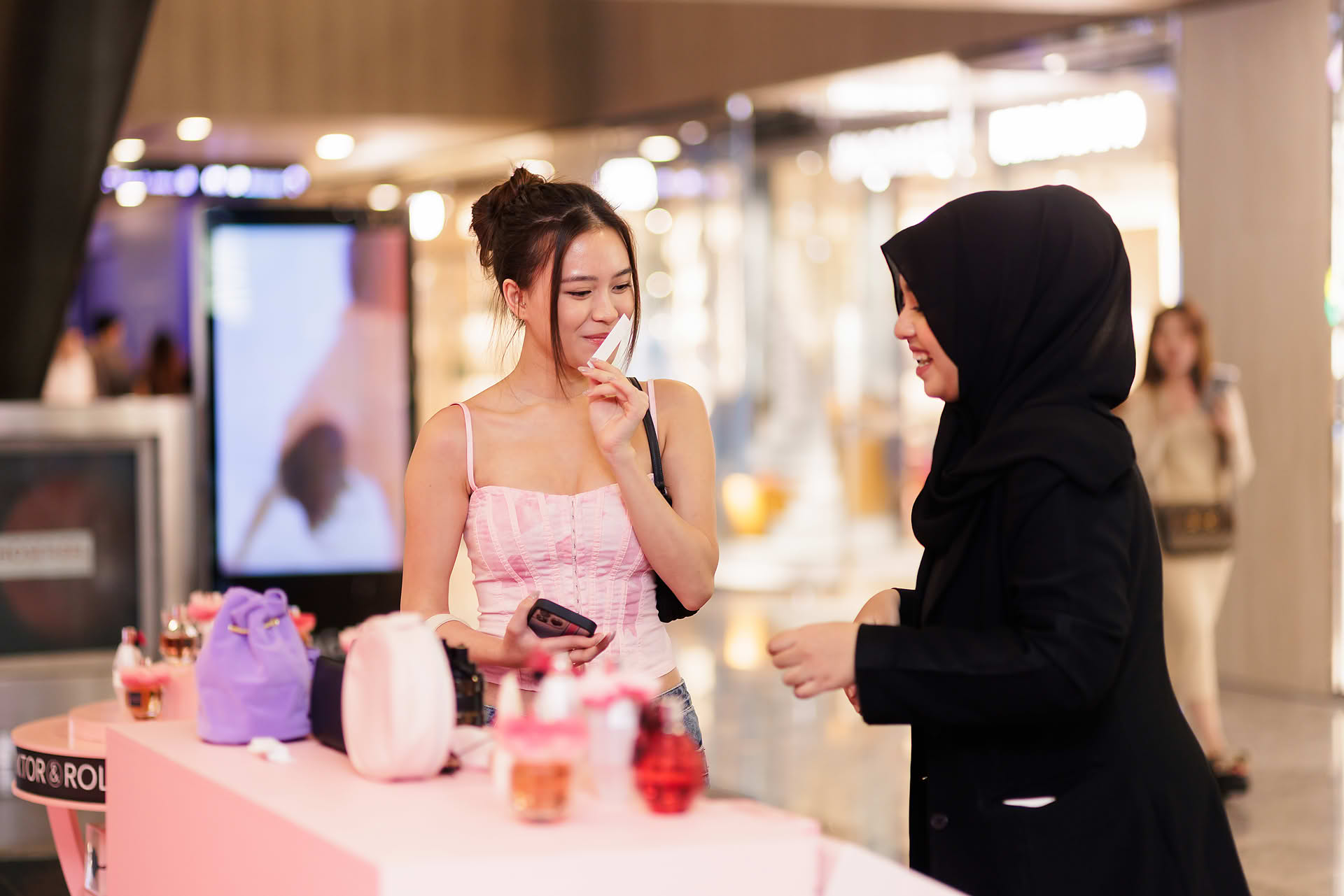 Influencer sniffing perfume at Vicktor Rolf Cafe pop-up stall in Paragon