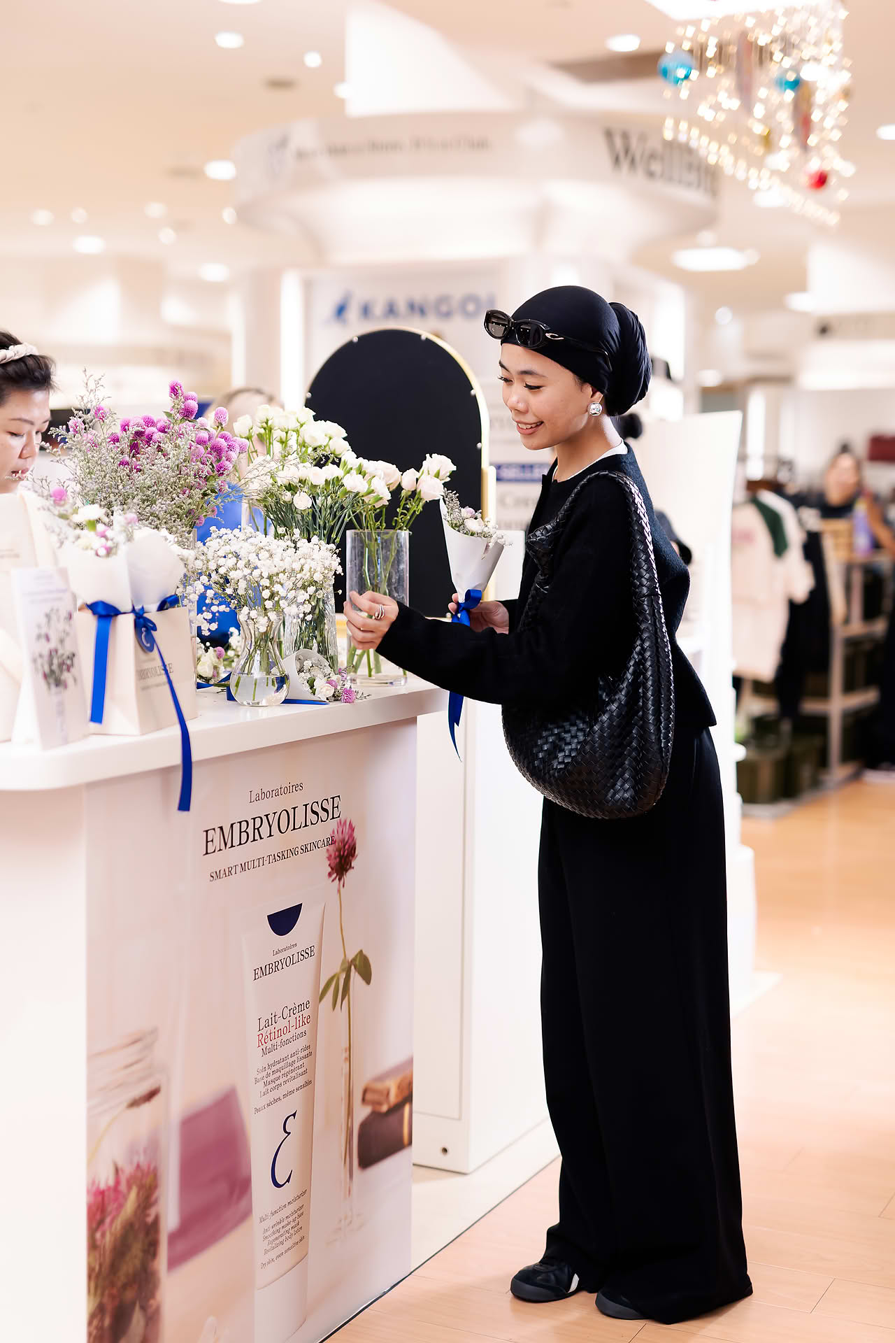 KOL picking flowers at Embryolisse stall in Ngee Ann City