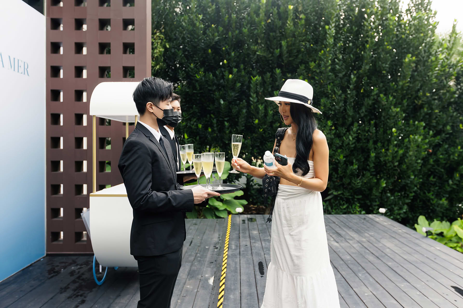 Guests taking a drink at La Mer PR event in Sentosa