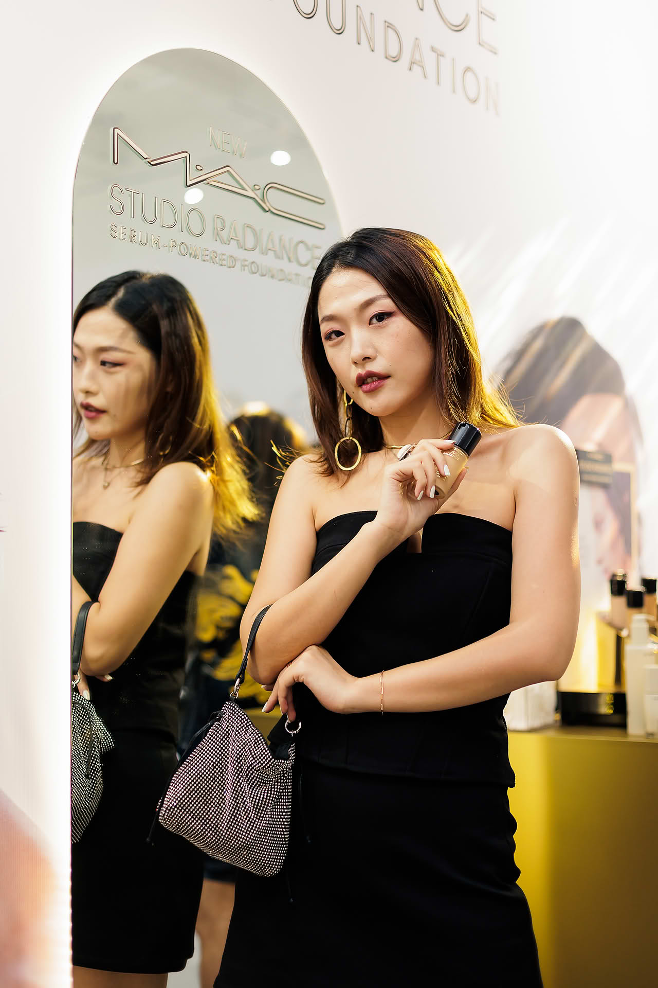 Influencer posing with product at MAC Cosmestics PR event
