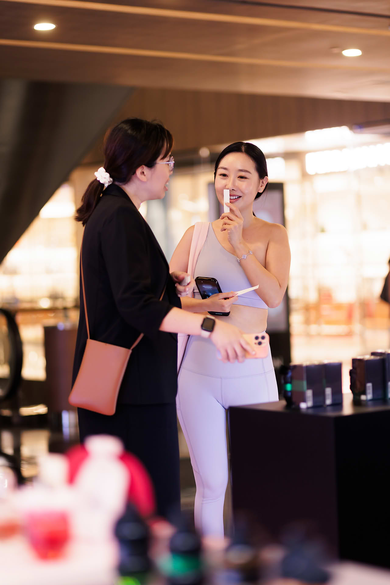 Influencer sniffing perfume at Vicktor Rolf Cafe pop-up stall in Paragon