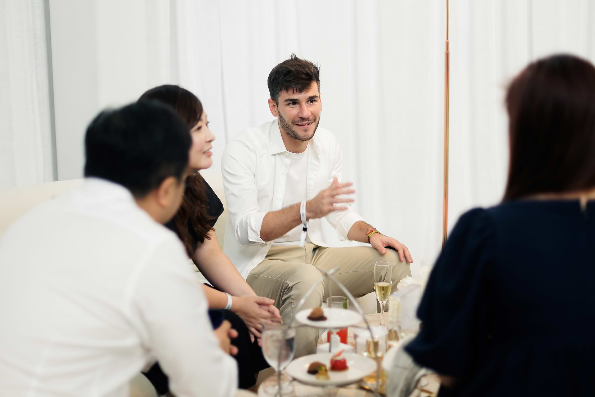 Men socializing at Estee Lauder Re-Nutriv PR event