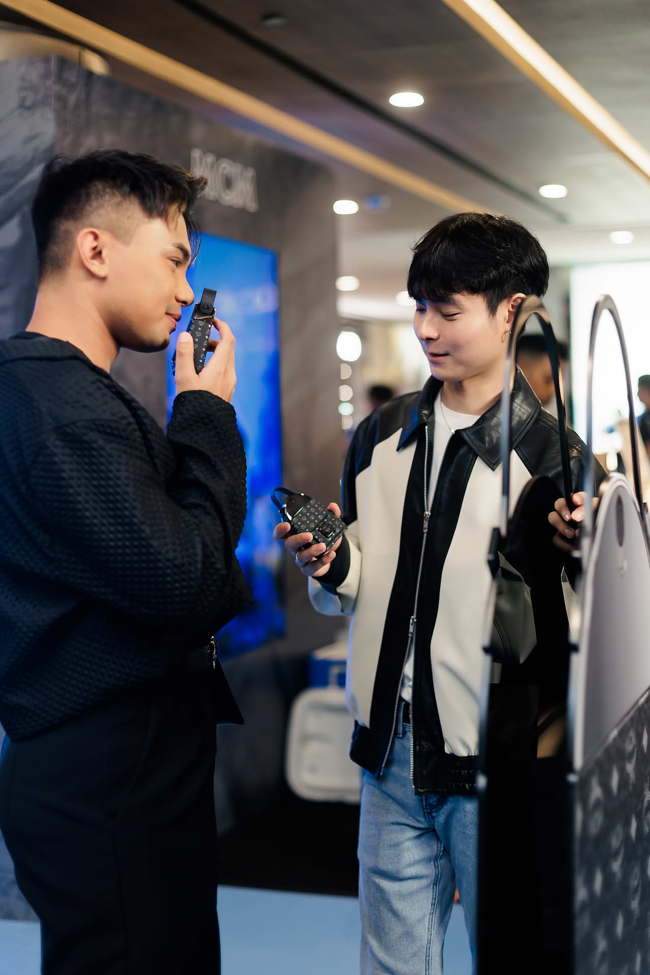Influencers testing perfume at MCM pop-up stall at Paragon