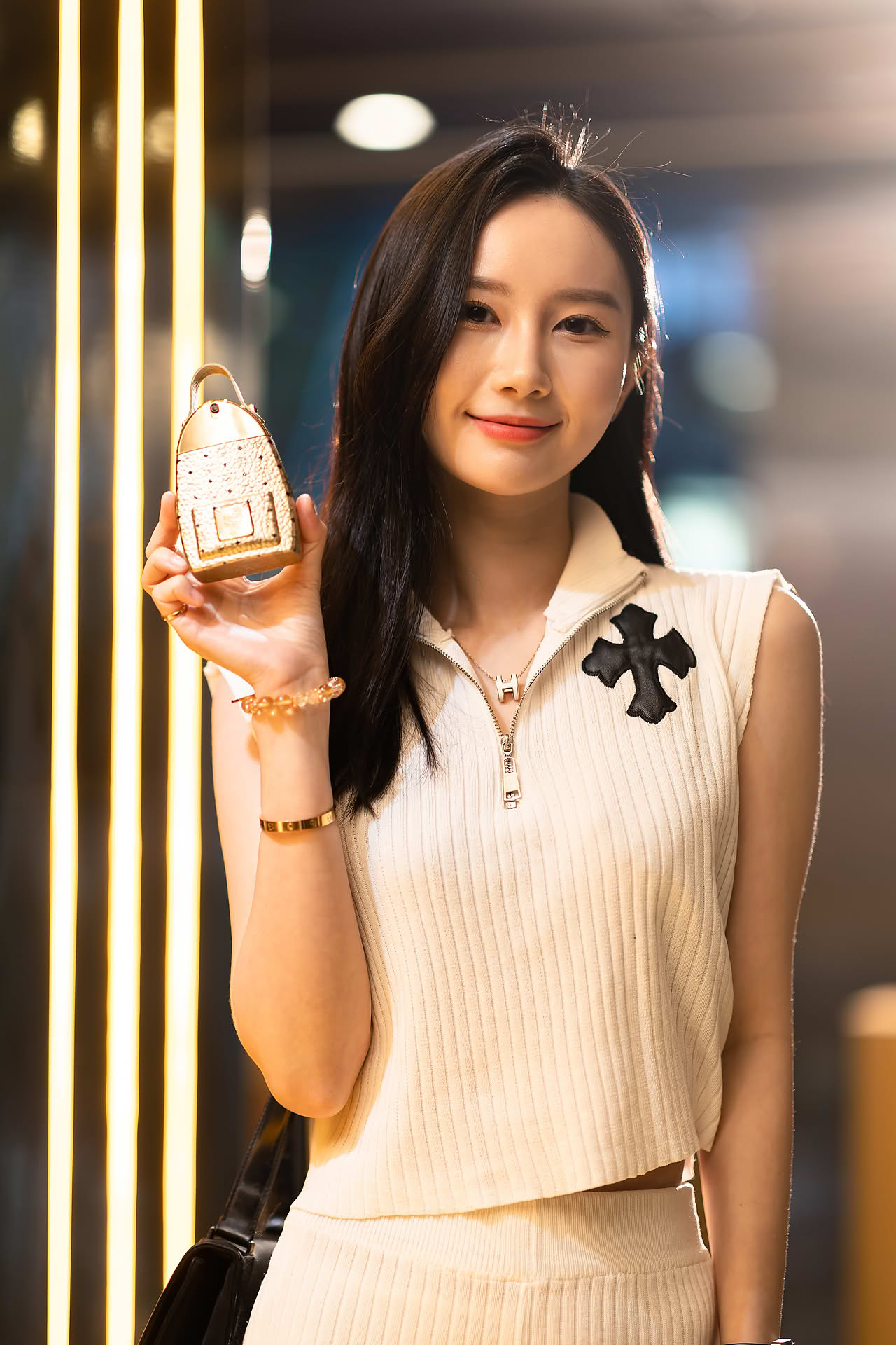 Influencer posing with MCM Ultra perfume to promote pop-up store