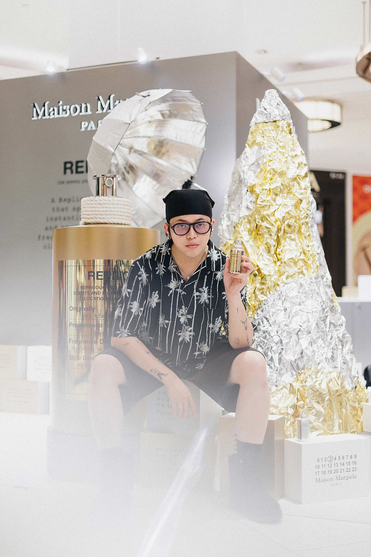 Influencer posing at Maison Margiela pop-up stall in Ngee Ann City