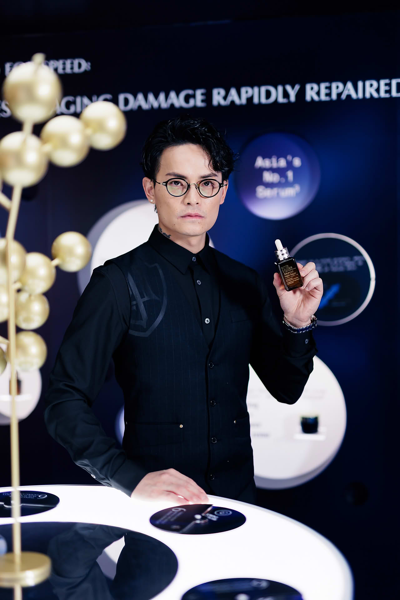 Korean makeup artist posing with a product at Estee Lauder PR event