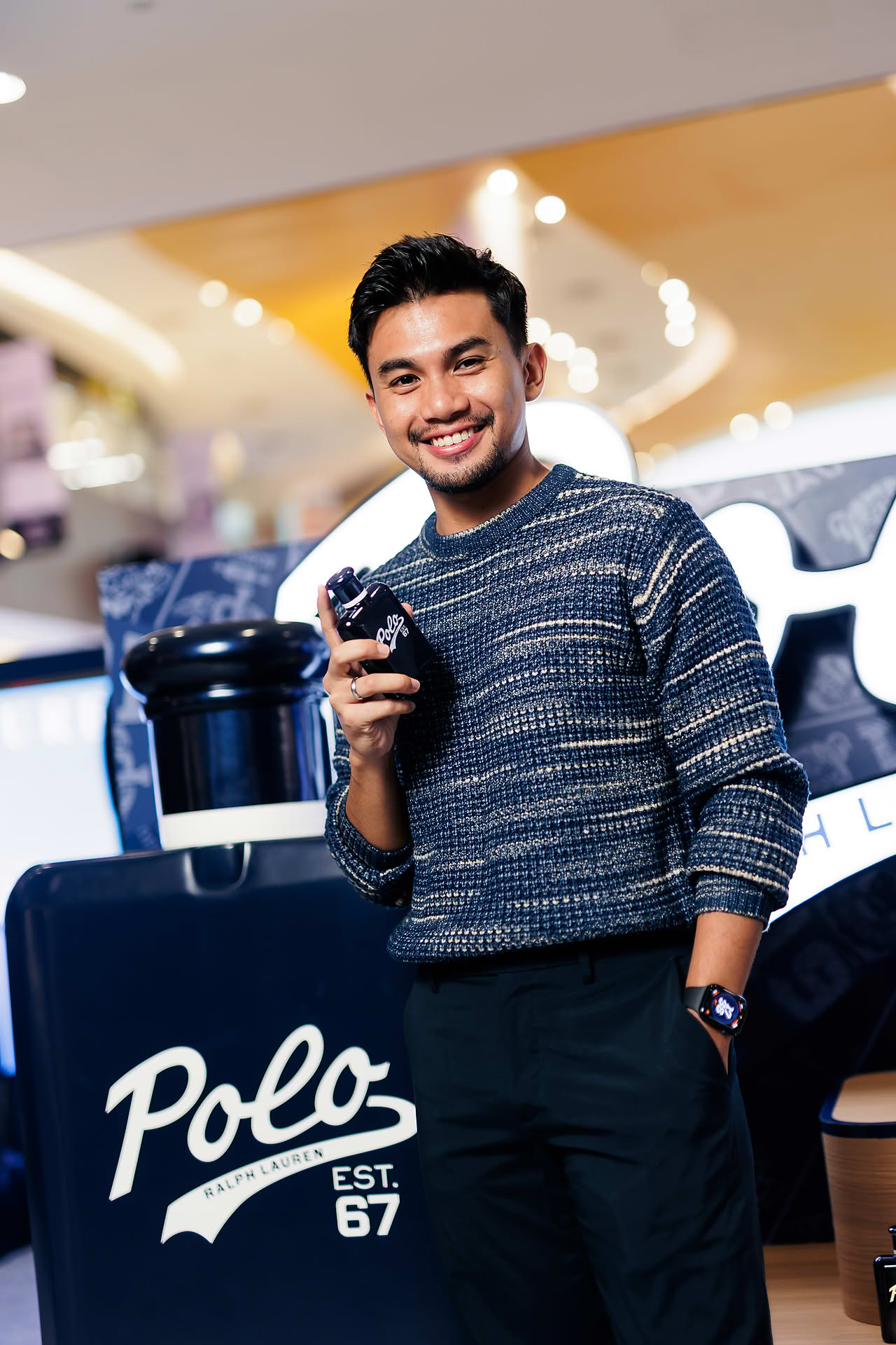 Influencer posing with Ralph Lauren Perfume at pop-up stall in Vivocity