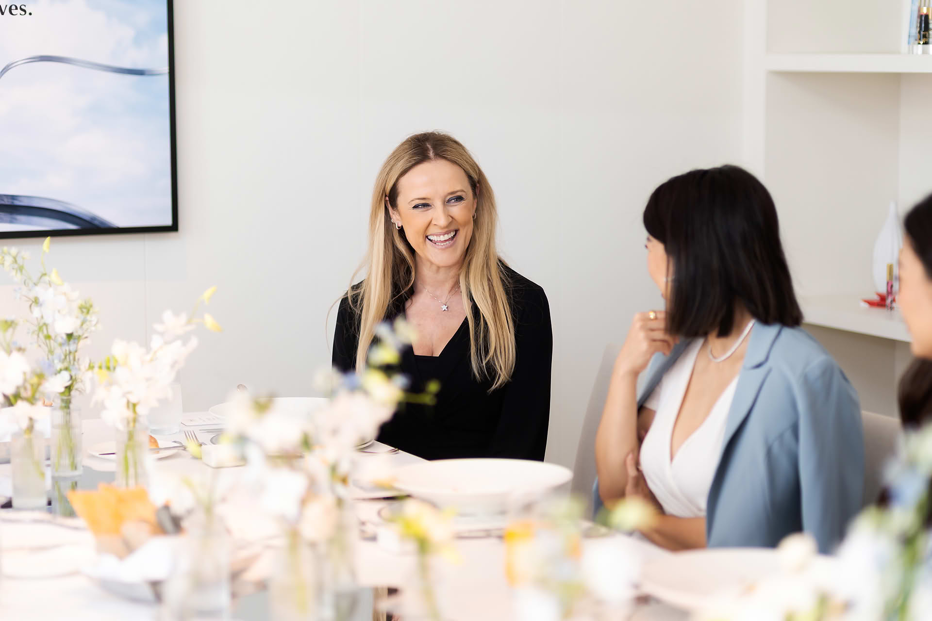 Guest talking at the lunch table at Diane von Furstenberg x Estee Lauder lunch event