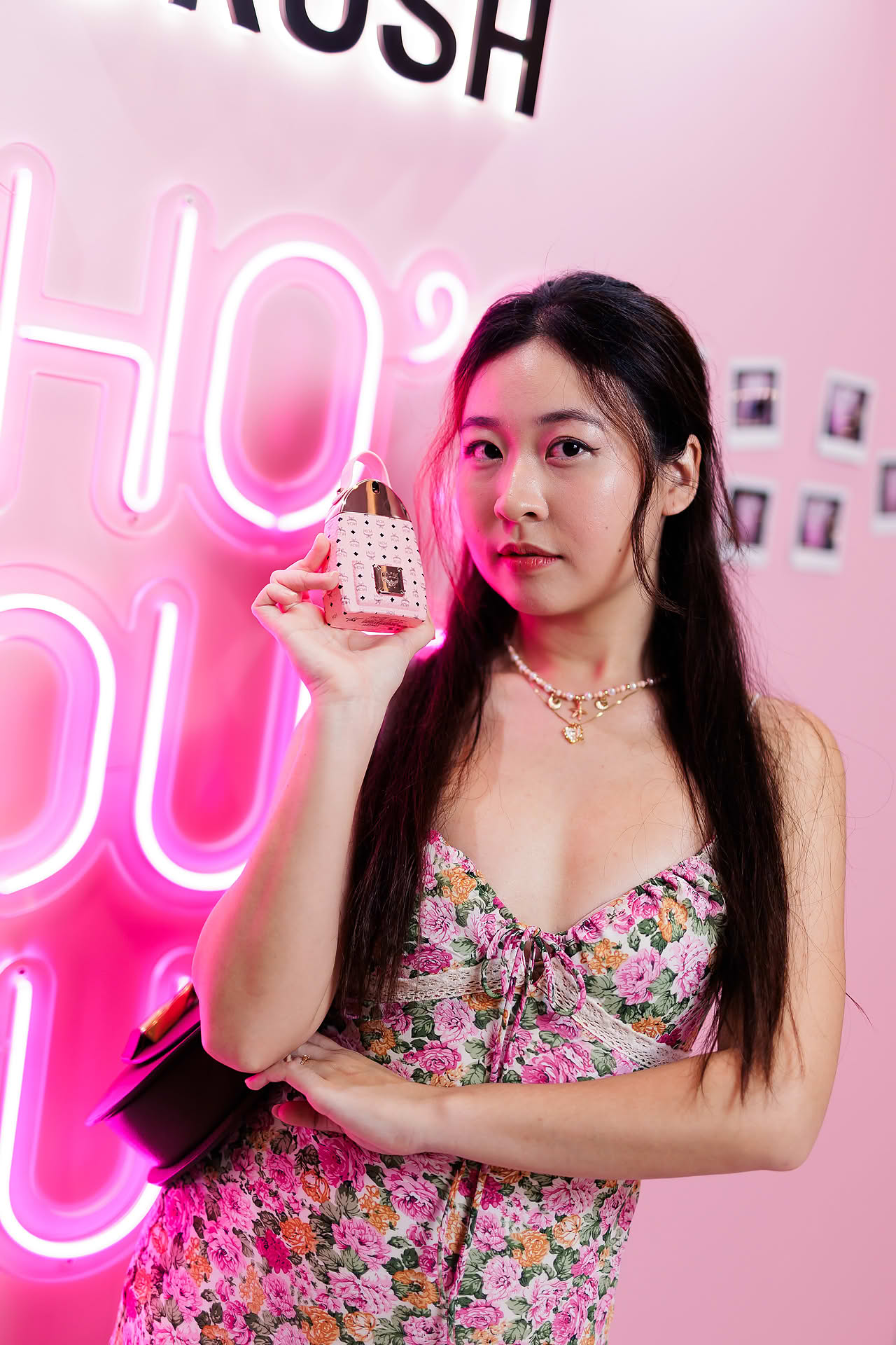 Influencer posing with MCM Crush perfume at pop-up stall in Ngee Ann City