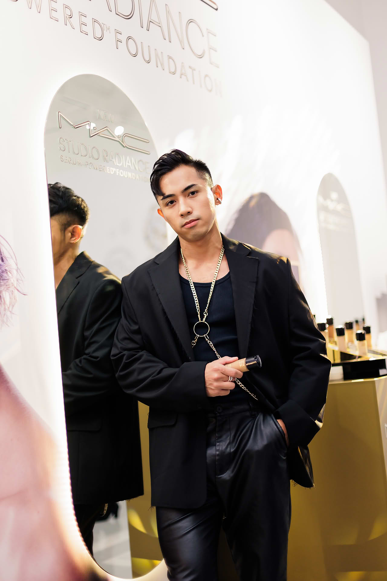 Influencer posing with product at MAC Cosmestics PR event