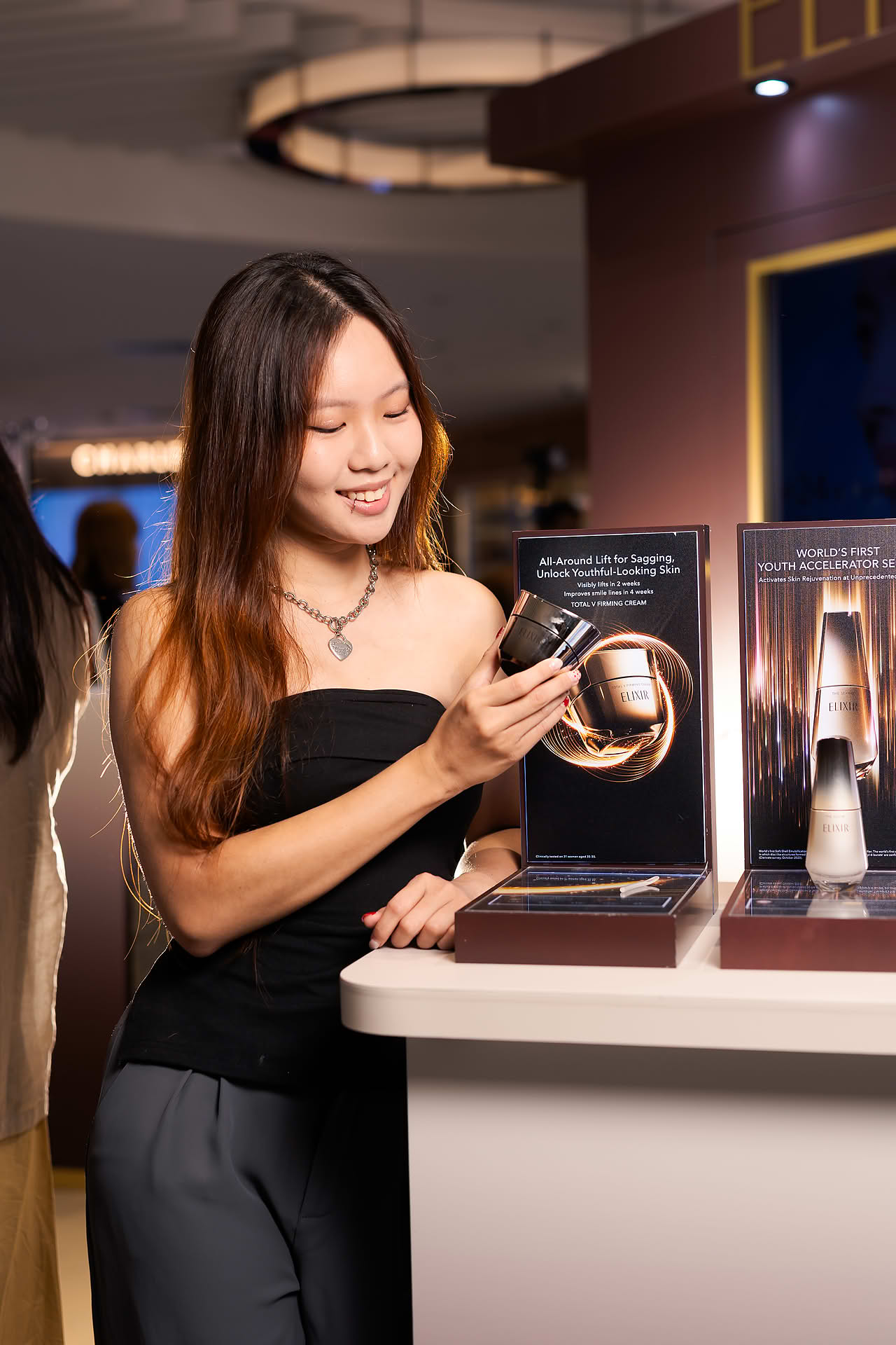 Model browsing products at Exlixir pop-up stall in Ngee Ann City