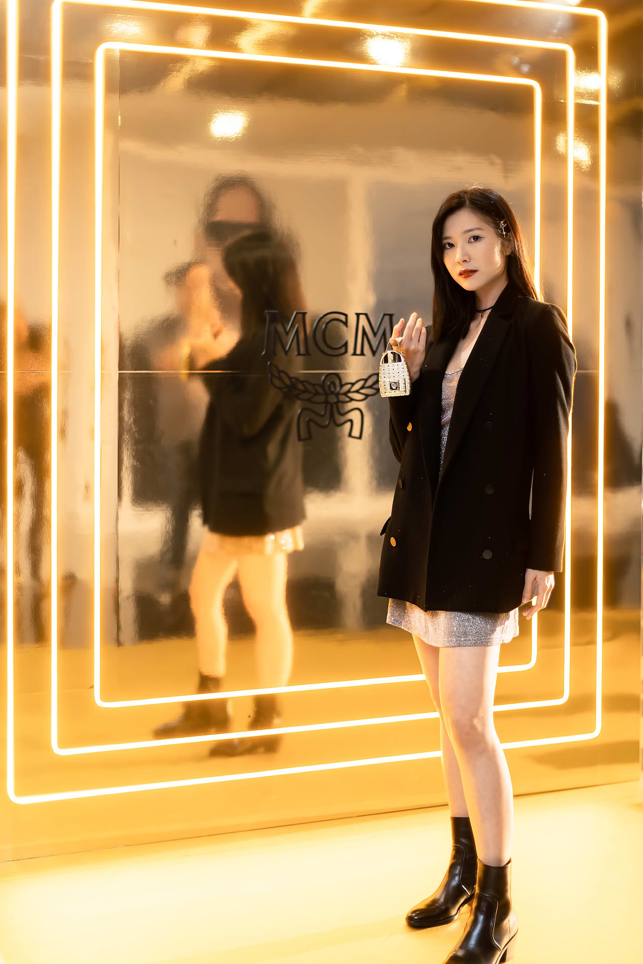 Influencer posing with MCM Ultra perfume to promote pop-up store