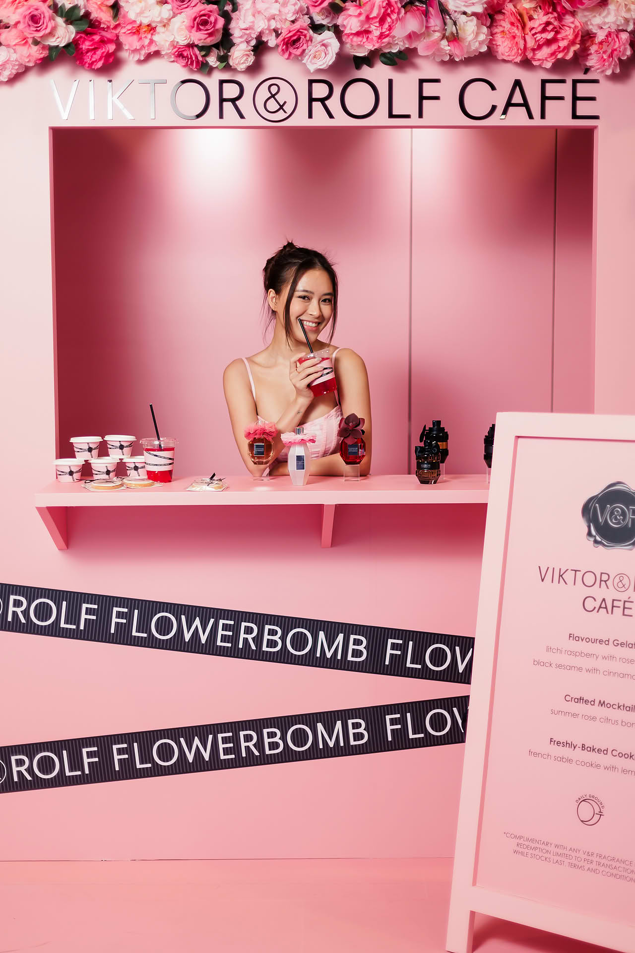 Influencer trying the drinks at Vicktor Rolf Cafe pop-up stall in Paragon