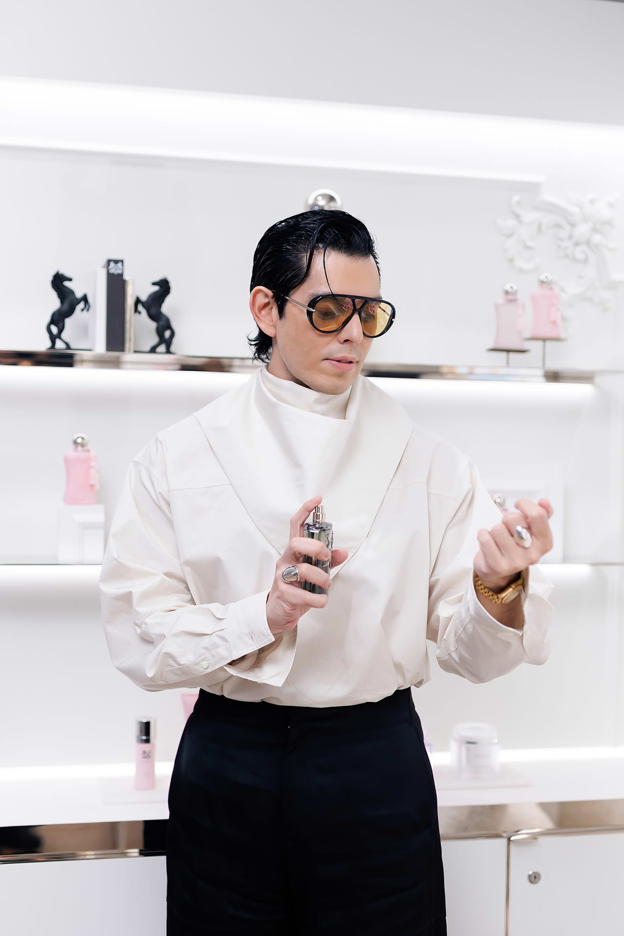 Influencer spraying perfume at Parfums de Marly launch event