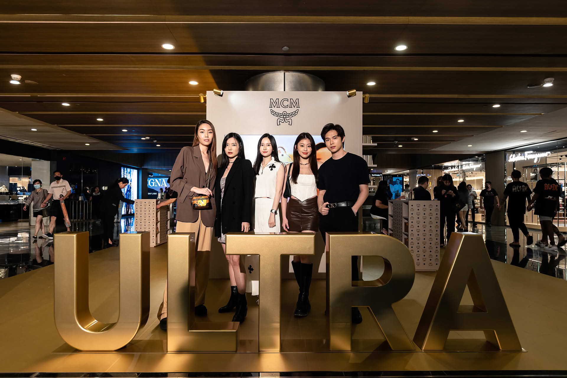 MCM Ultra group photo with influencers at pop-up stall