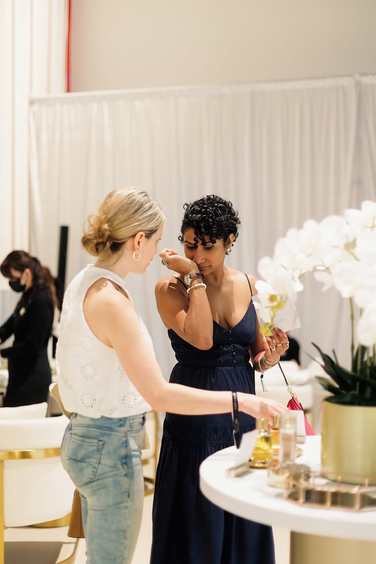 Customer smelling Estee Lauder Re-Nutriv