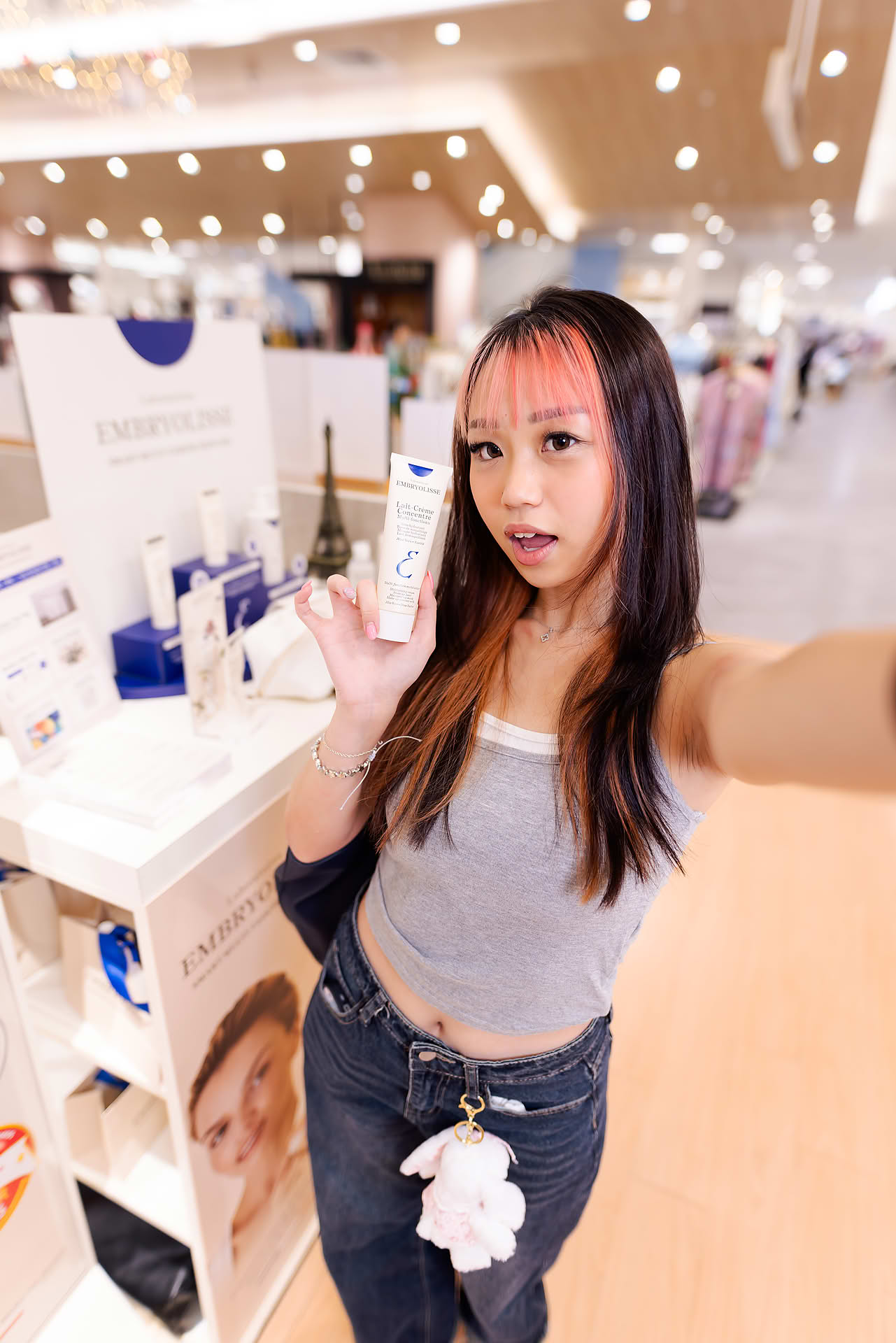 KOL taking selfie at Embryolisse stall in Ngee Ann City