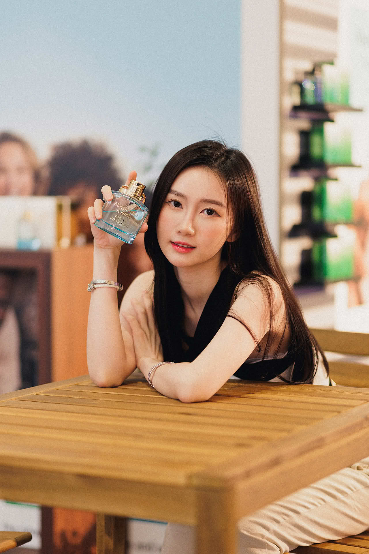 Influencer posing with Abercrombie and Fitch perfume