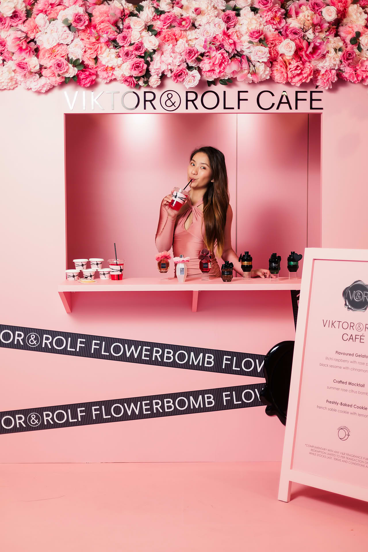 Influencer trying the drinks at Vicktor Rolf Cafe pop-up stall in Paragon