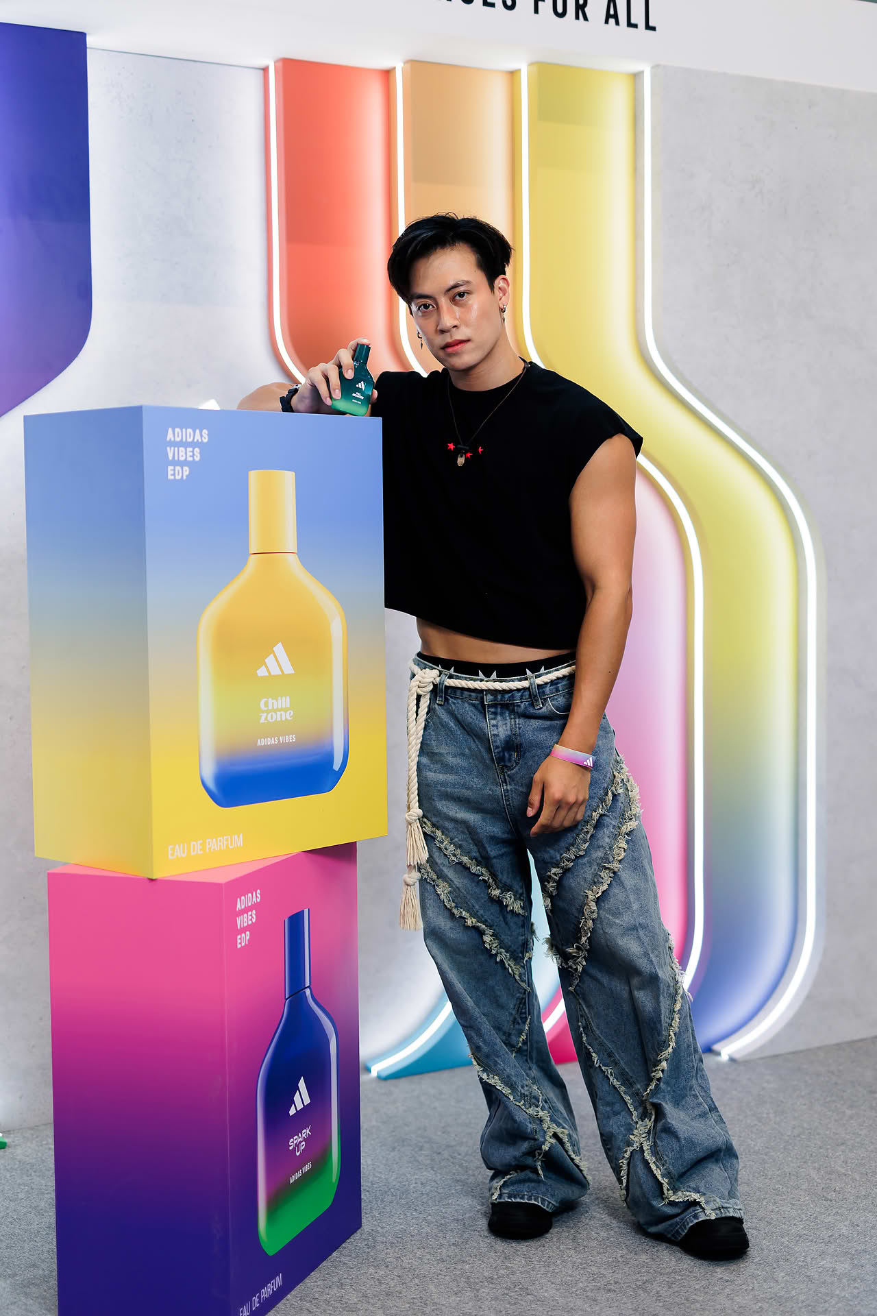 Influencer posing with perfume at Addidas Vibe pop-up stall in Plaza Singapura