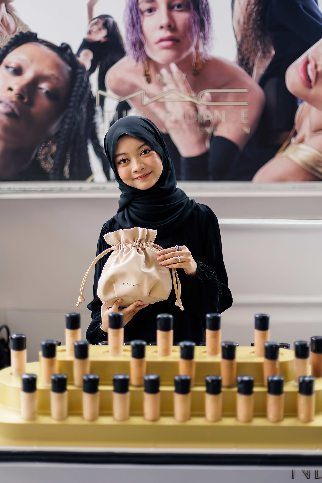 MAC Staff holding gift bag