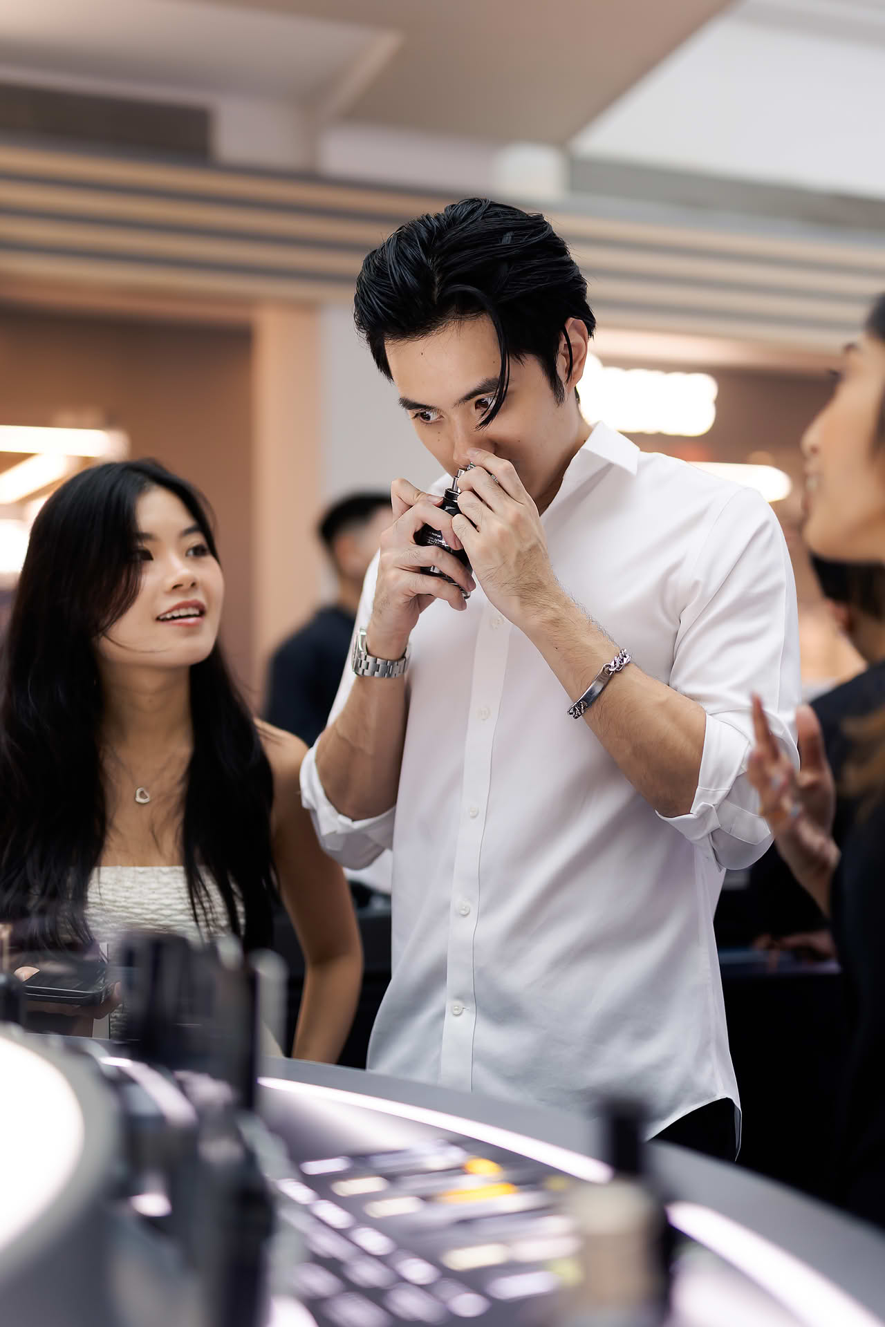 Influencer smelling perfume at BOSS pop-up stall in Bugis Junction