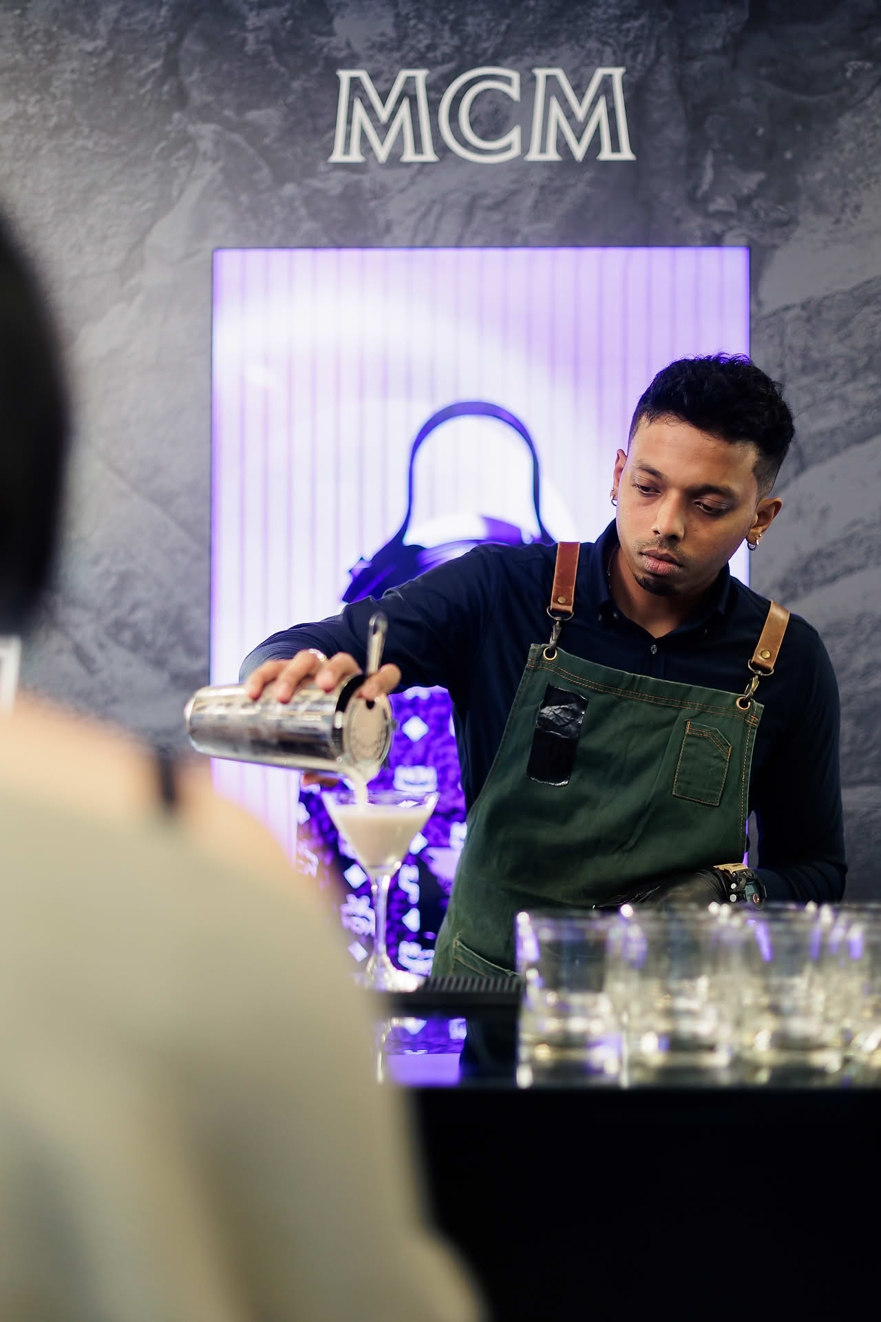 Bar tender preparing drinks at MCM pop-up stall at Paragon