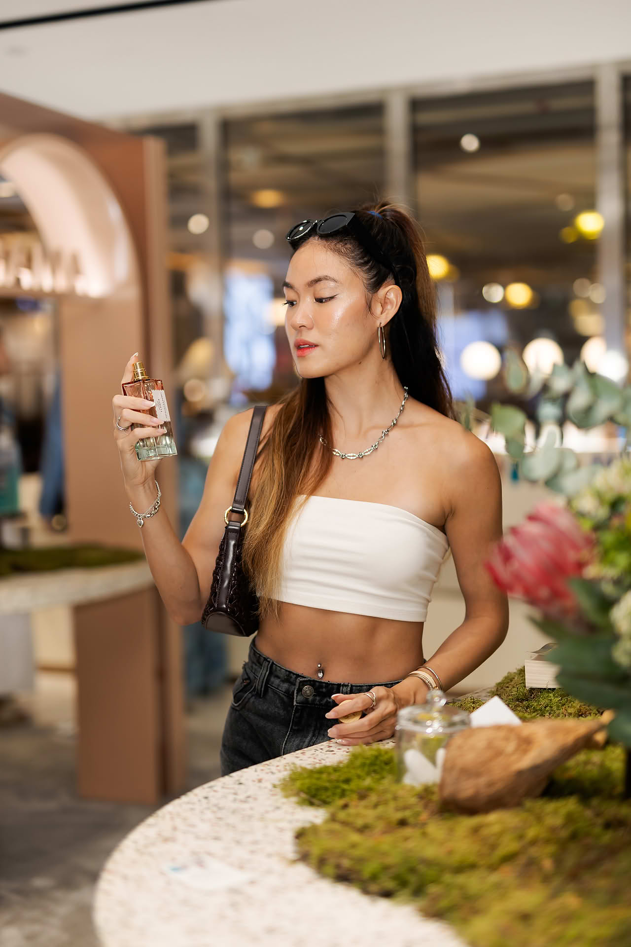 Influencer spraying perfume at Goldfield & Banks PR event