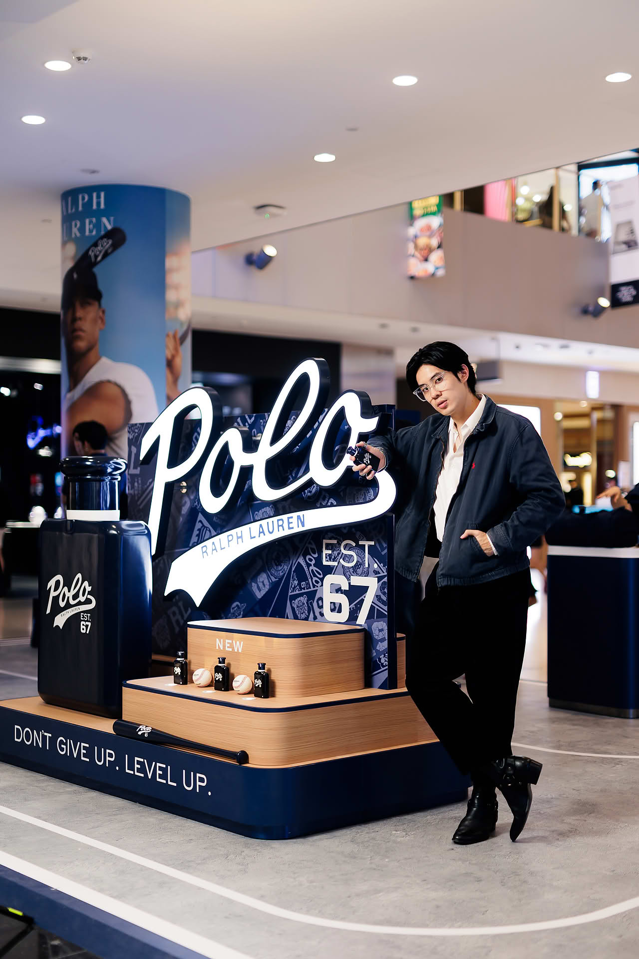 Influencer posing with Ralph Lauren Perfume at pop-up stall in Vivocity