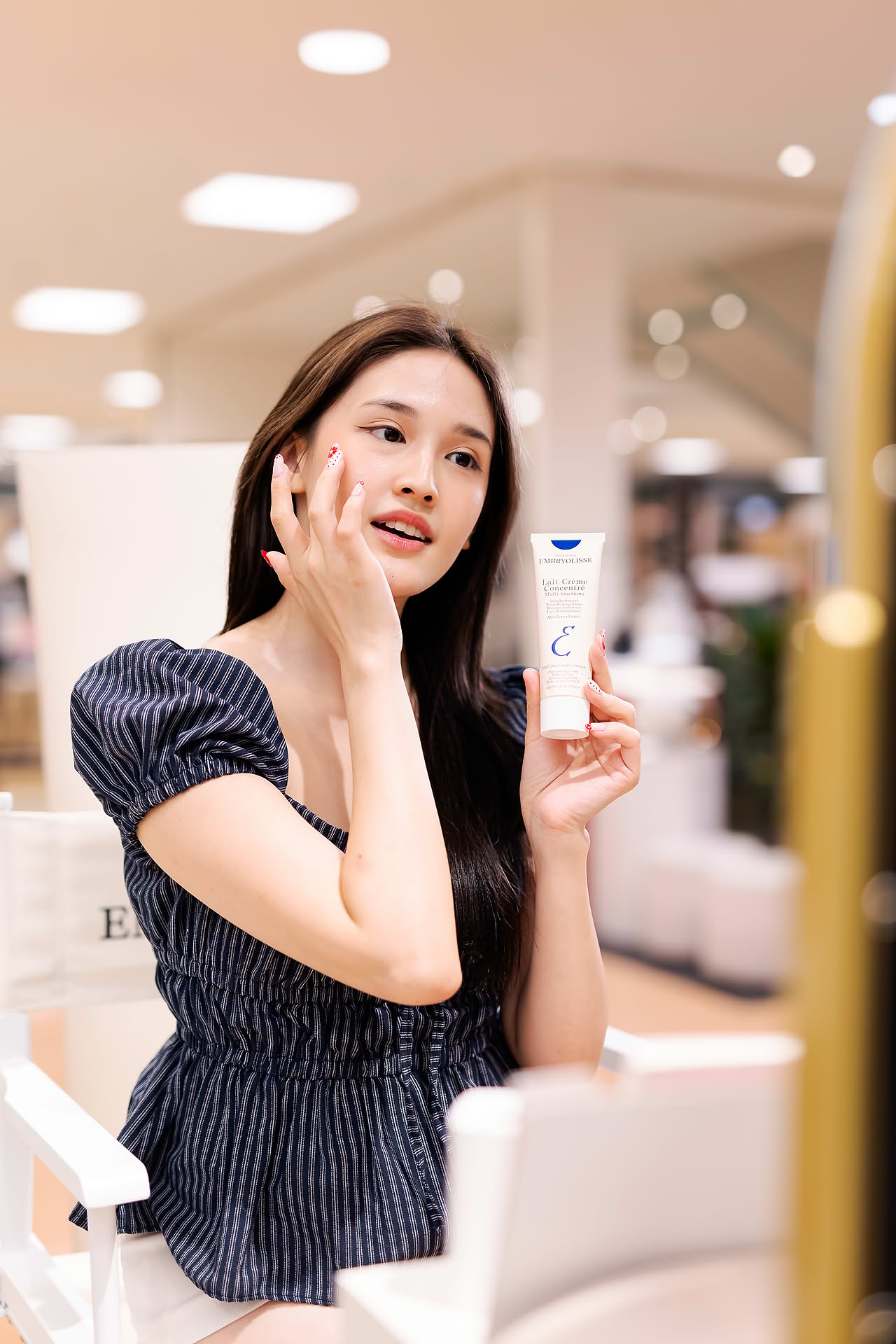 KOL applying cream at Embryolisse stall in Ngee Ann City